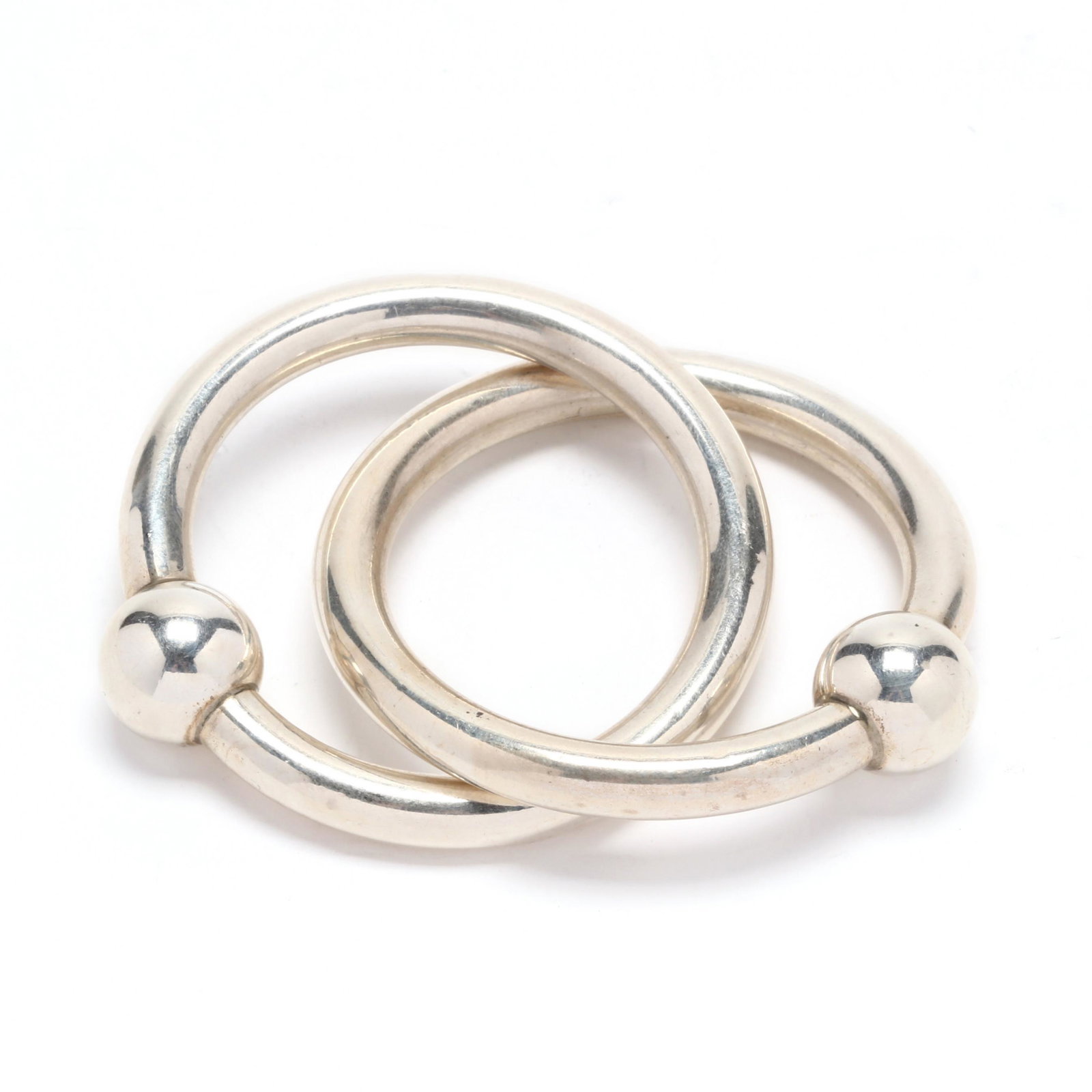 Tiffany & Co. Sterling Silver Baby Rattle: Tiffany & Co. Sterling Silver Baby Rattle no apparent hallmark, of interlocking double rings, presented in the original Tiffany & Co. pouch and box. 1.05 troy oz. Additional high-resolution photos are