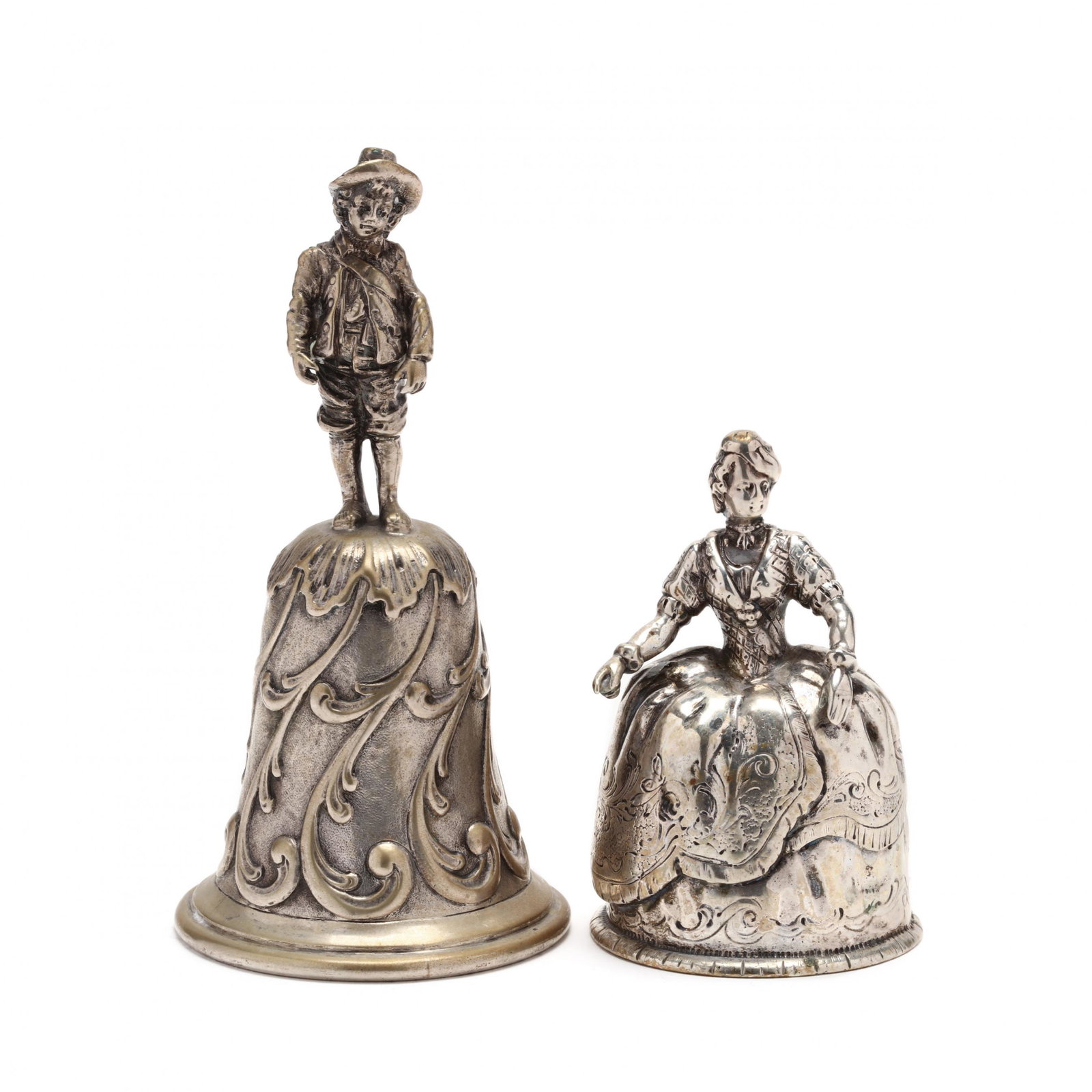 Two Antique Hanau Silver Figural Bells: Two Antique Hanau Silver Figural Bells the first cast in the form of a young woman in a dramatic ballgown, marked for .800 silver (3 3/8 in.); the second featuring a casting of a young boy atop a bell