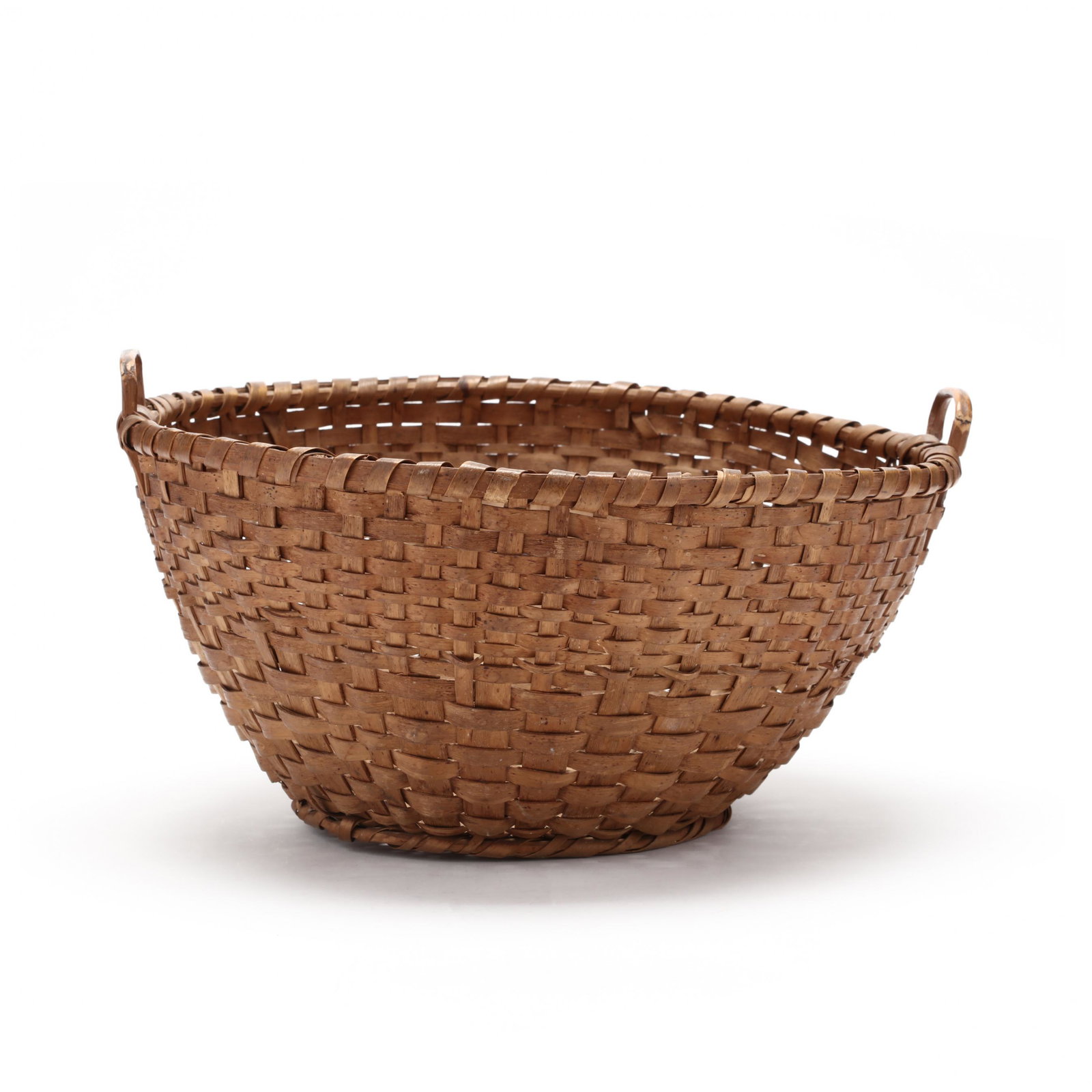Southern Splint Handled Basket: Southern Splint Handled Basketcirca 1900, likely Western North Carolina, circular open form with two arched handles notched into the upper rim for stability, circular footed base. 6.25 x 12 in. diamet