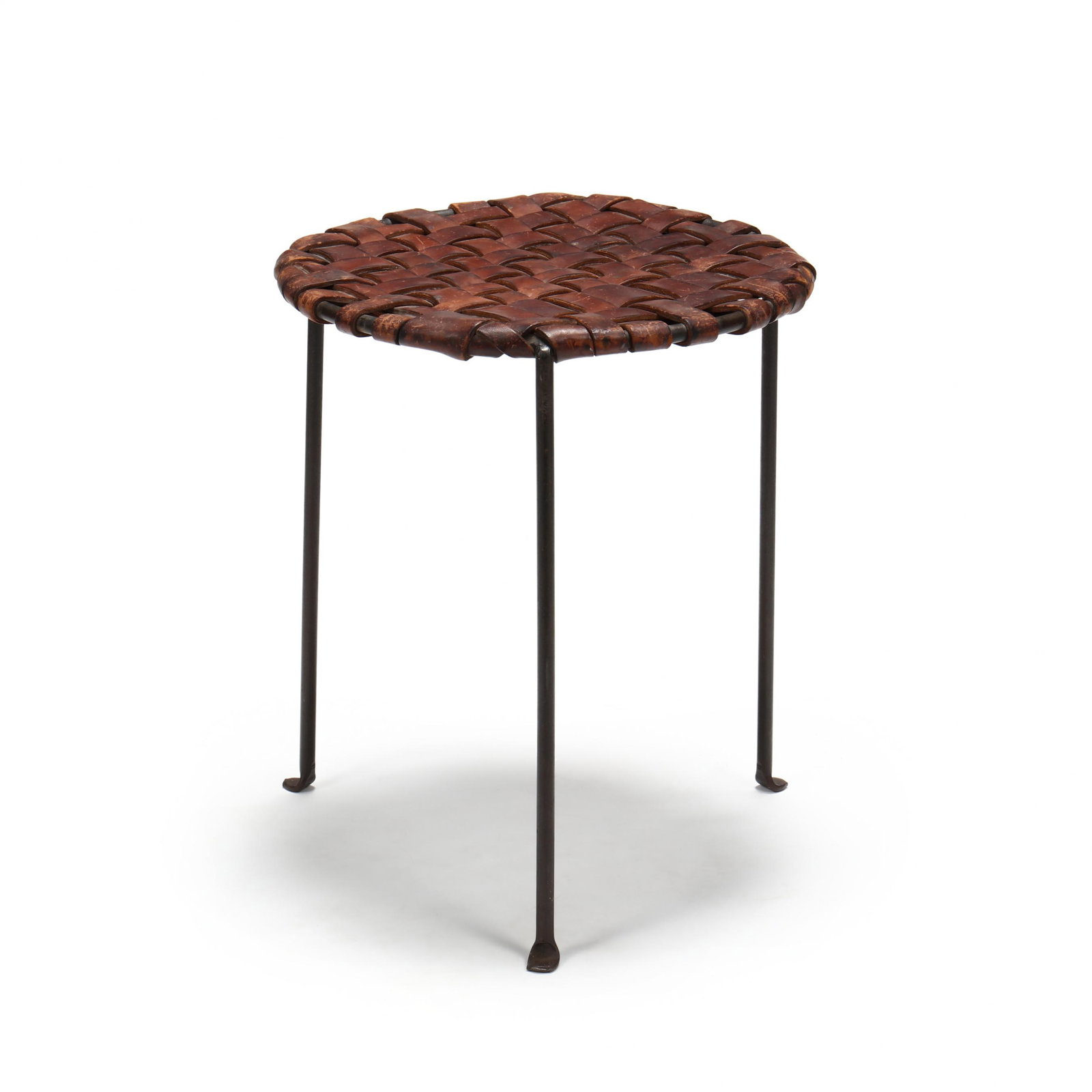 Swift and Monell, Leather and Iron Stool: Swift and Monell, Leather and Iron Stool American, circa 1955, designed by Lila Swift and Donald Monell, original woven brown leather seat on a black painted iron base, unmarked. 18 x 15 in. diameter 