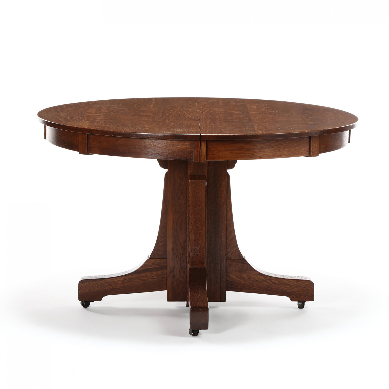 Stickley Brothers, Mission Oak Dining Table and Leaves: Stickley Brothers, Mission Oak Dining Table and Leaves circa 1910, quarter sawn oak, circular top opens to accept three leaves, pedestal base on casters, lacking original label. 30 x 48 in. diameter; 