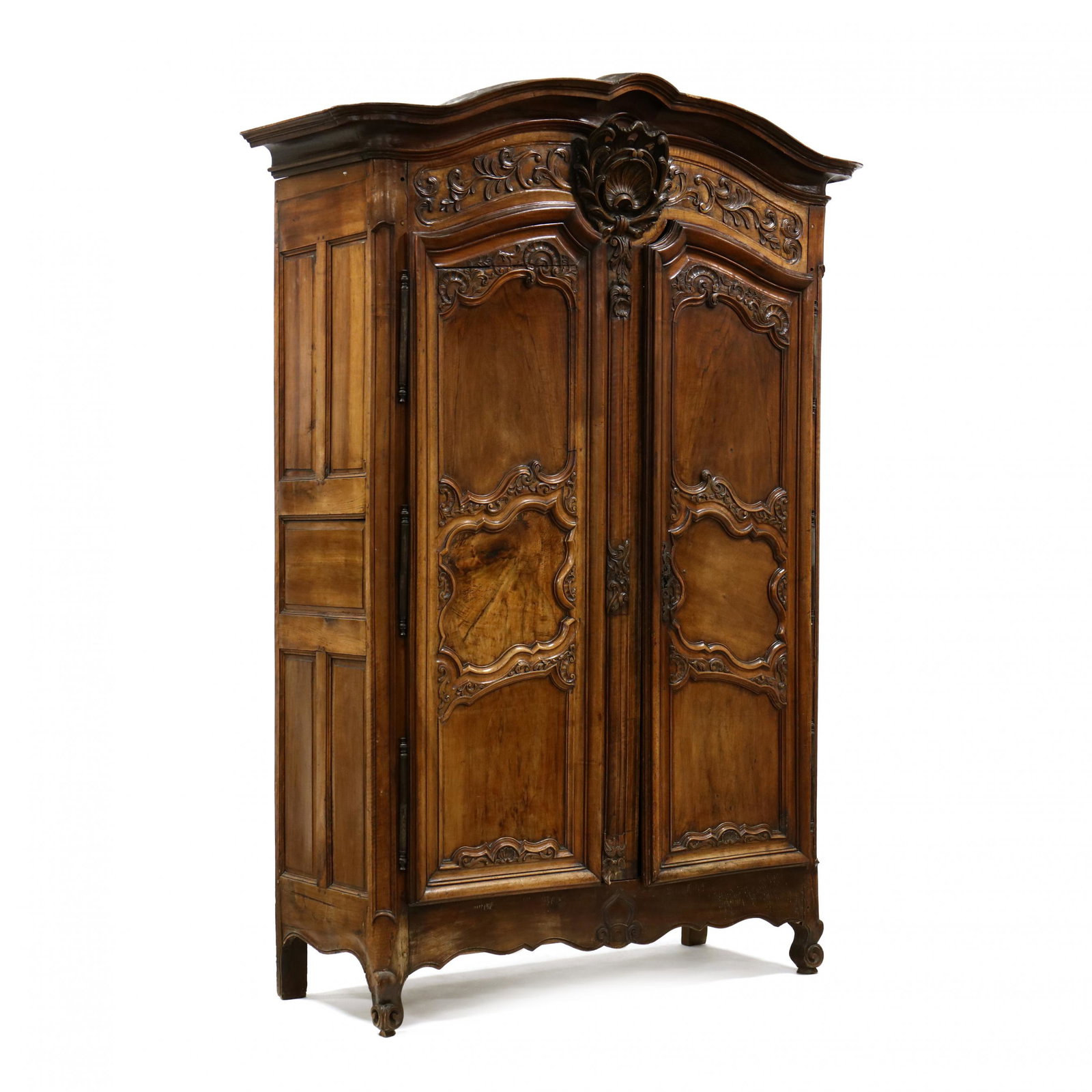 Louis XV Carved Walnut Large Armoire: Louis XV Carved Walnut Large Armoire 18th century, multi-part form, shaped deep cove-molded cornice with central floral carved element, case with two hinged relief carved triple panel doors, with stee