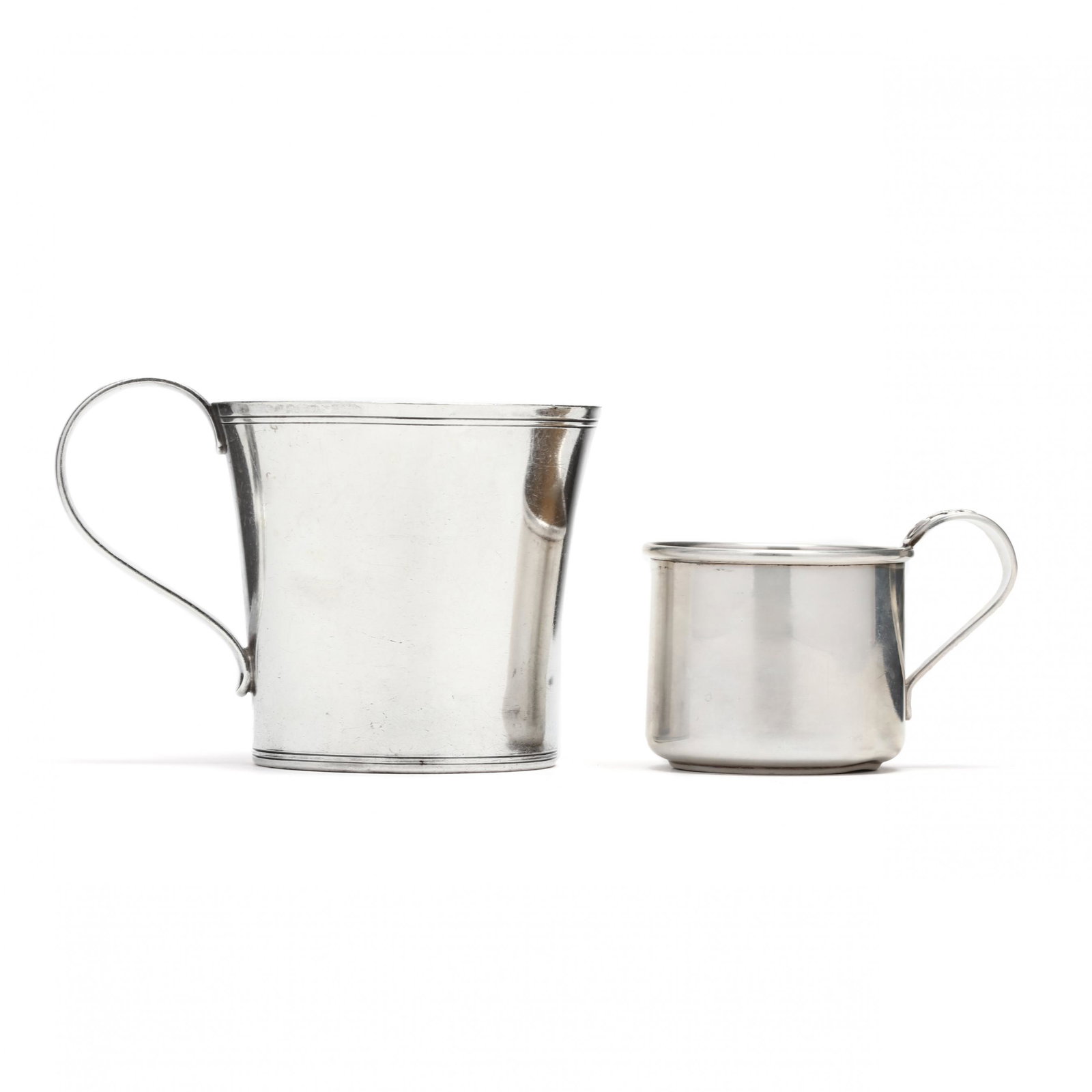 Two Sterling Silver Cups: Two Sterling Silver Cups the first with mark of Georg Jensen Inc. USA, model number 1263 (2.75 in.) (some denting); the second a Frank M. Whiting parcel gilt child's cup (2 in.). 5.25 total troy oz. A