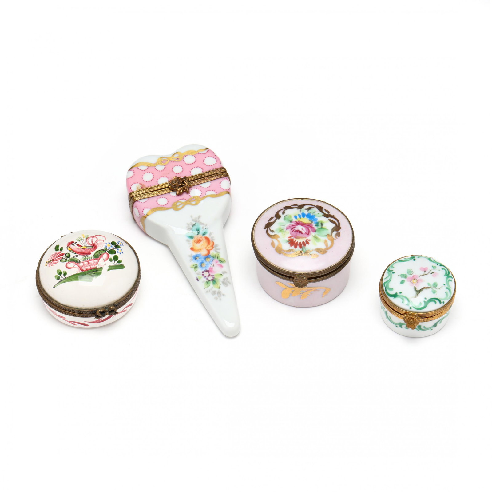 Four French Porcelain Pill Boxes: Four French Porcelain Pill Boxes three are round in form with hand-painted floral decoration, (largest 1.5 x 1 7/8 in.) the fourth is heart shaped with an elongated handle (4.25 in.) Private Collectio