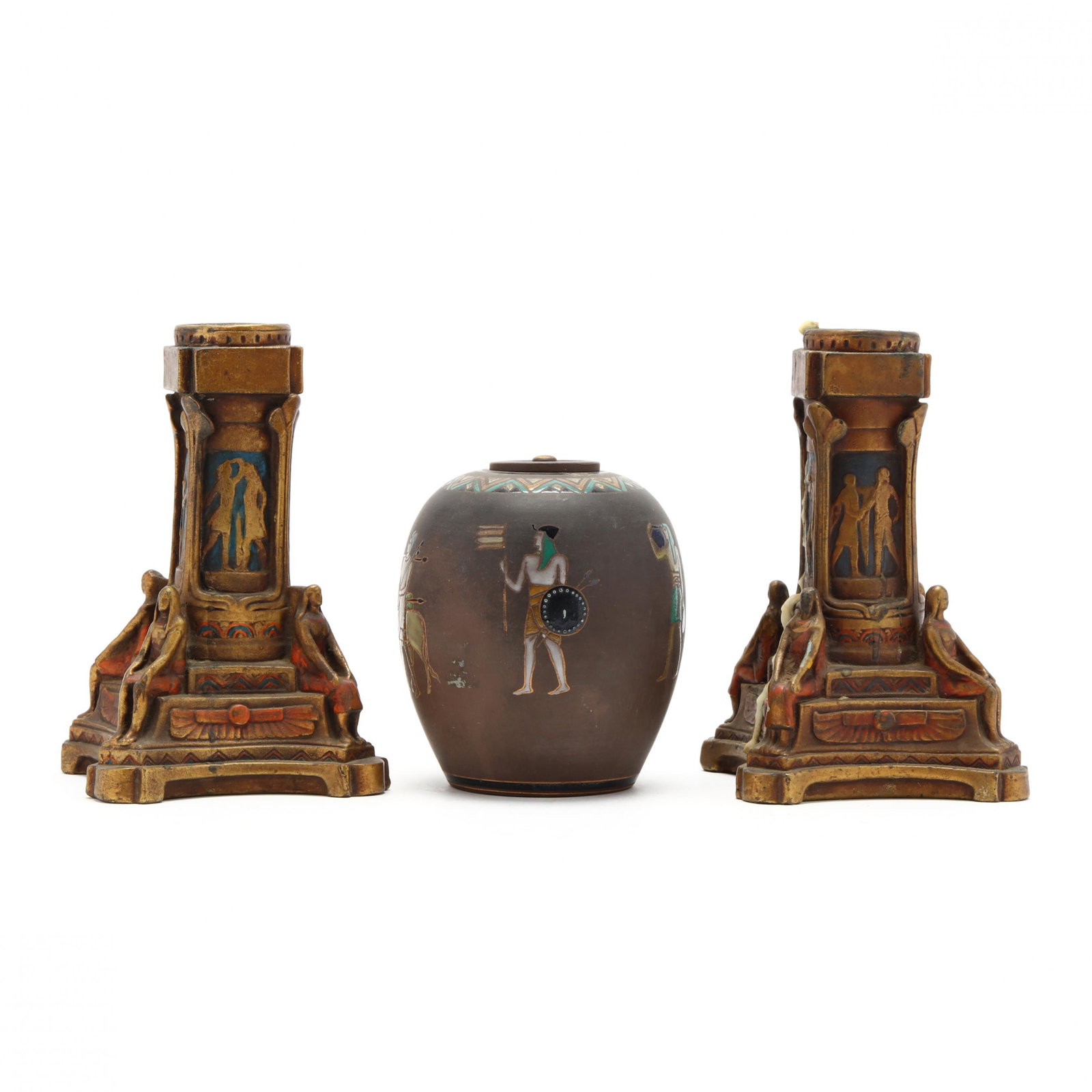 Egyptian Revival Decorative Accessories: Egyptian Revival Decorative Accessories circa 1900, including a Nippon lidded porcelain jar, and a pair of metal clad candlesticks, unmarked. Tallest 8 in. From the Collection of Patricia Ann Leahy, F