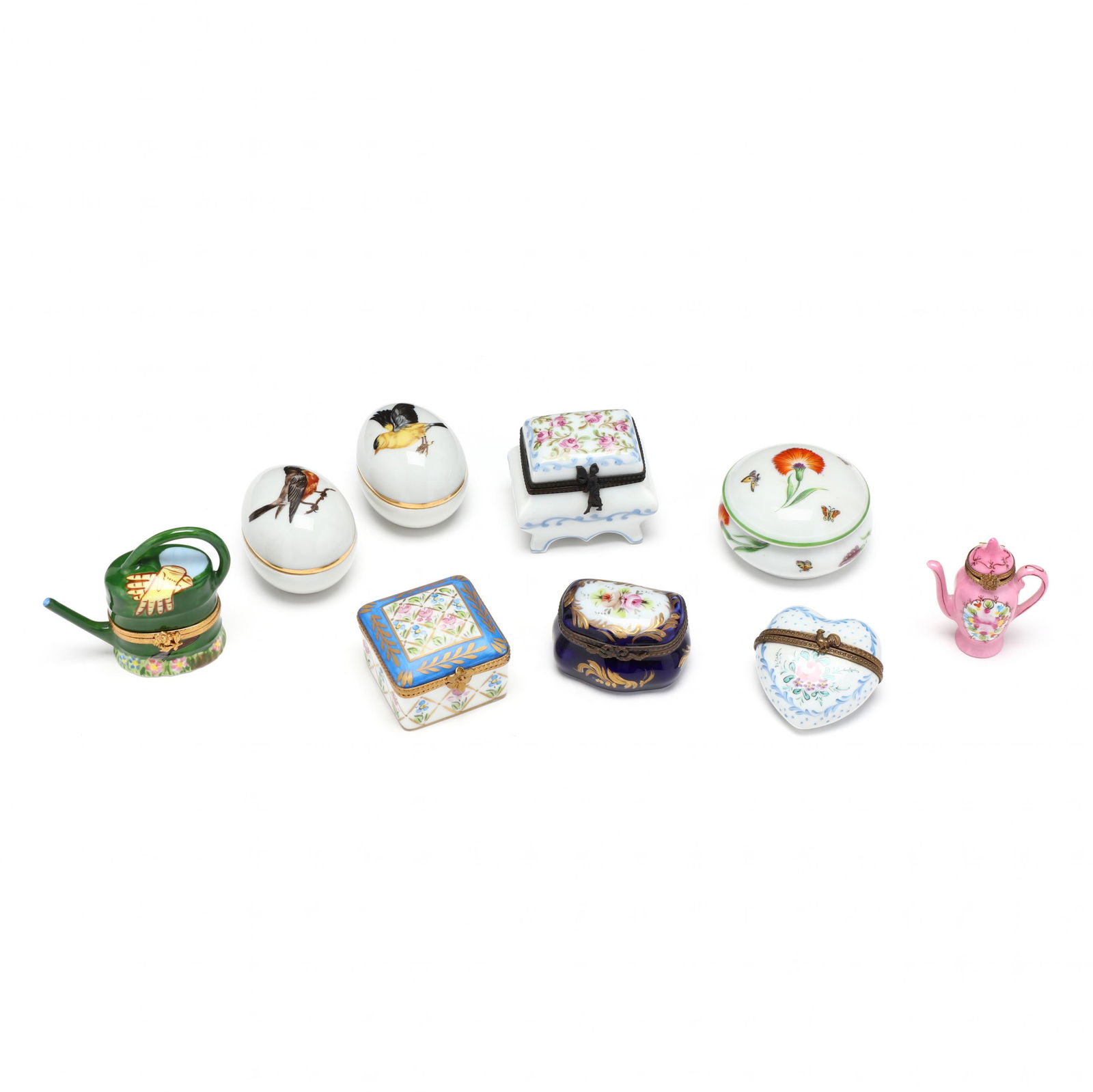 Nine Handpainted Limoges Pill Boxes: Nine Handpainted Limoges Pill Boxesincluding a watering can, teapot, heart-shaped, ottoman, square box with flowers, pillow-form box with blue background, two egg-form boxes with bird decoration, and