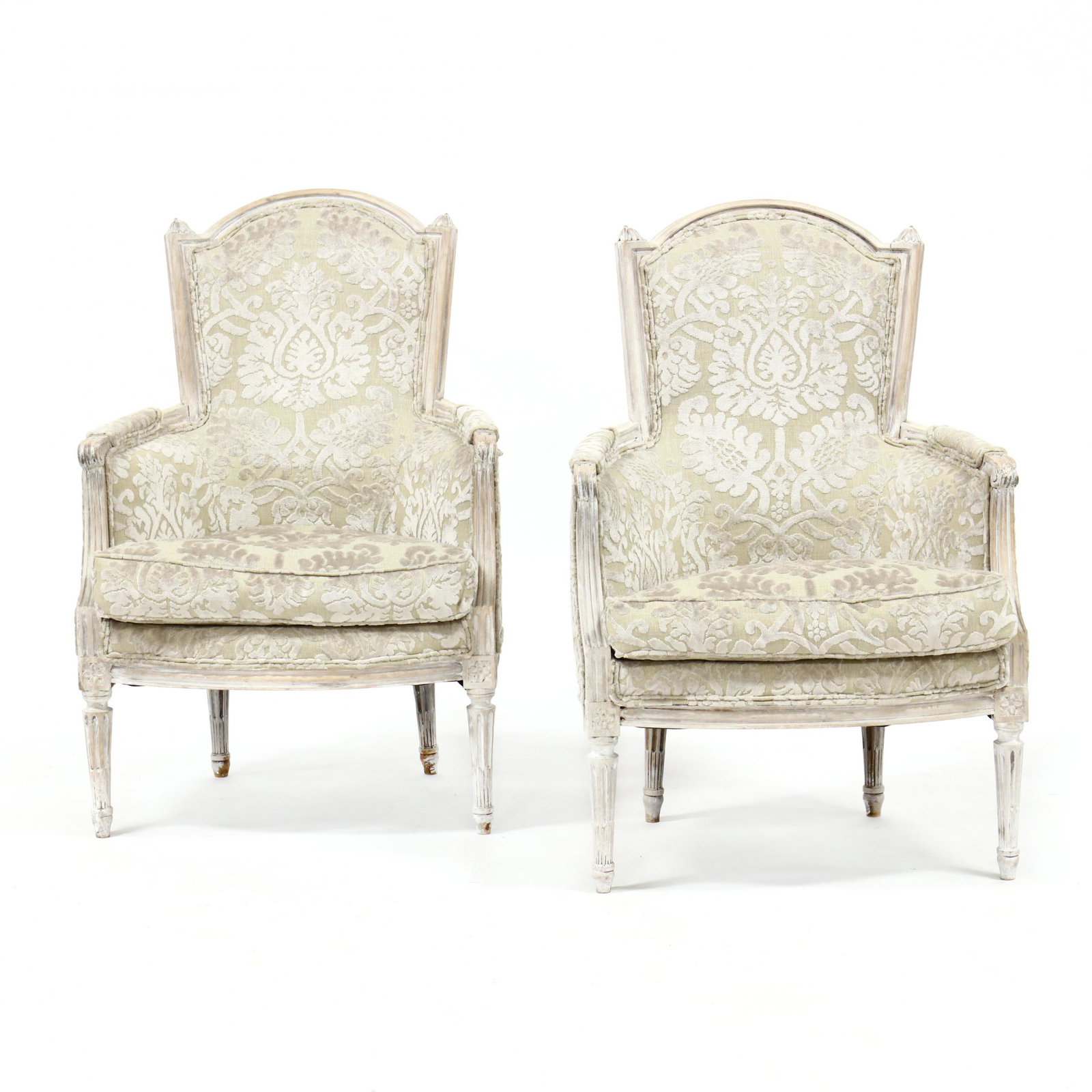Pair of Louis XVI Style Carved and Painted Bergeres: Pair of Louis XVI Style Carved and Painted Bergeres late 20th century, carved wood with whitewash finish, raised plush damask upholstery, loose down-filled cushions, on stop fluted legs. 38.5 x 26 x 2