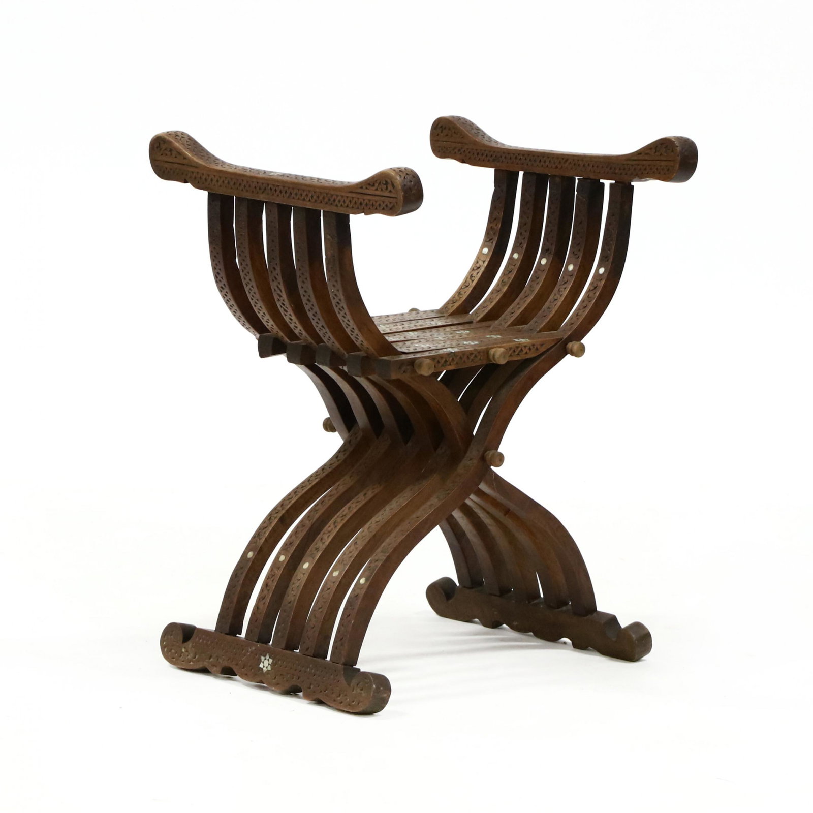 Middle Eastern Carved and Inlaid Savonarola Chair: Middle Eastern Carved and Inlaid Savonarola Chair early to mid 20th century, carved walnut with mother of pearl inlays, slat form on scrolled shoe feet. 26.5 x 20 x 18 in., seat height 16.75 in. From 