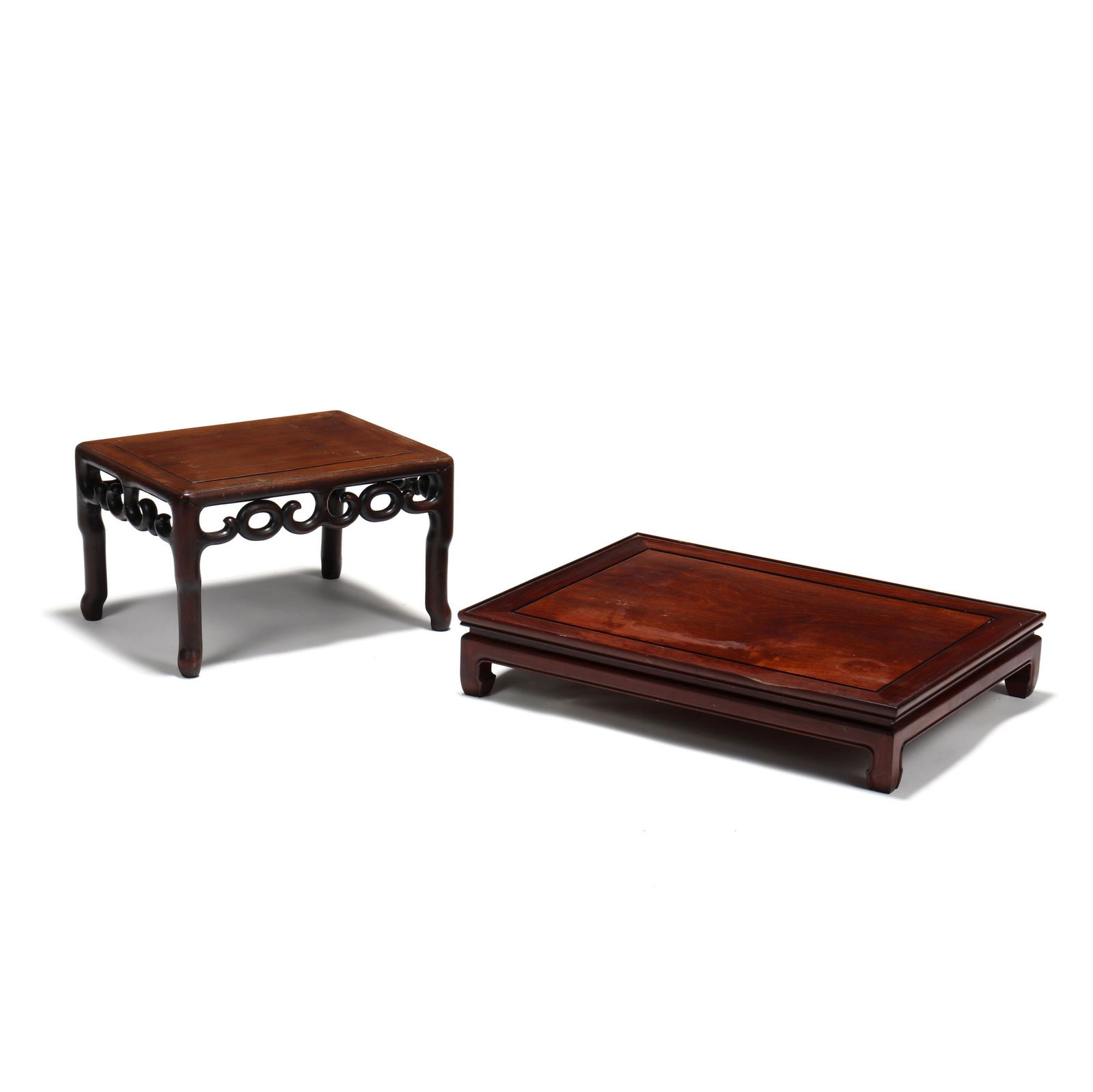 Two Chinese Carved Hongmu Low Tables: Two Chinese Carved Hongmu Low Tablesincludes a 19th century rectangular paneled top table with ring and scrolled carved skirt, on turned shaped legs (12.25 x 15 x 20.5 in.), and a 20th century rectang