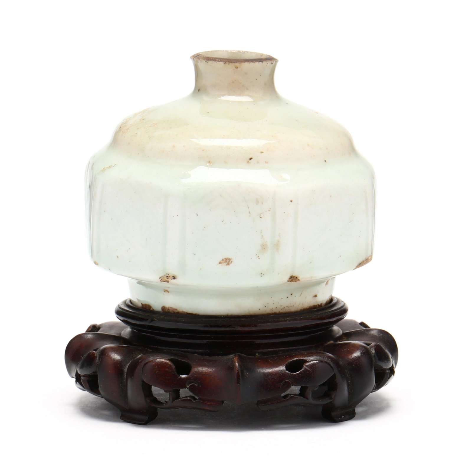 A Korean Octagonal Porcelain Jar: A Korean Octagonal Porcelain Jar Joseon dynasty (1392-1910), 19th century, octagonal shape to sides, very light celadon glaze to body, incised floral decoration to sides, underside with kiln grit alon