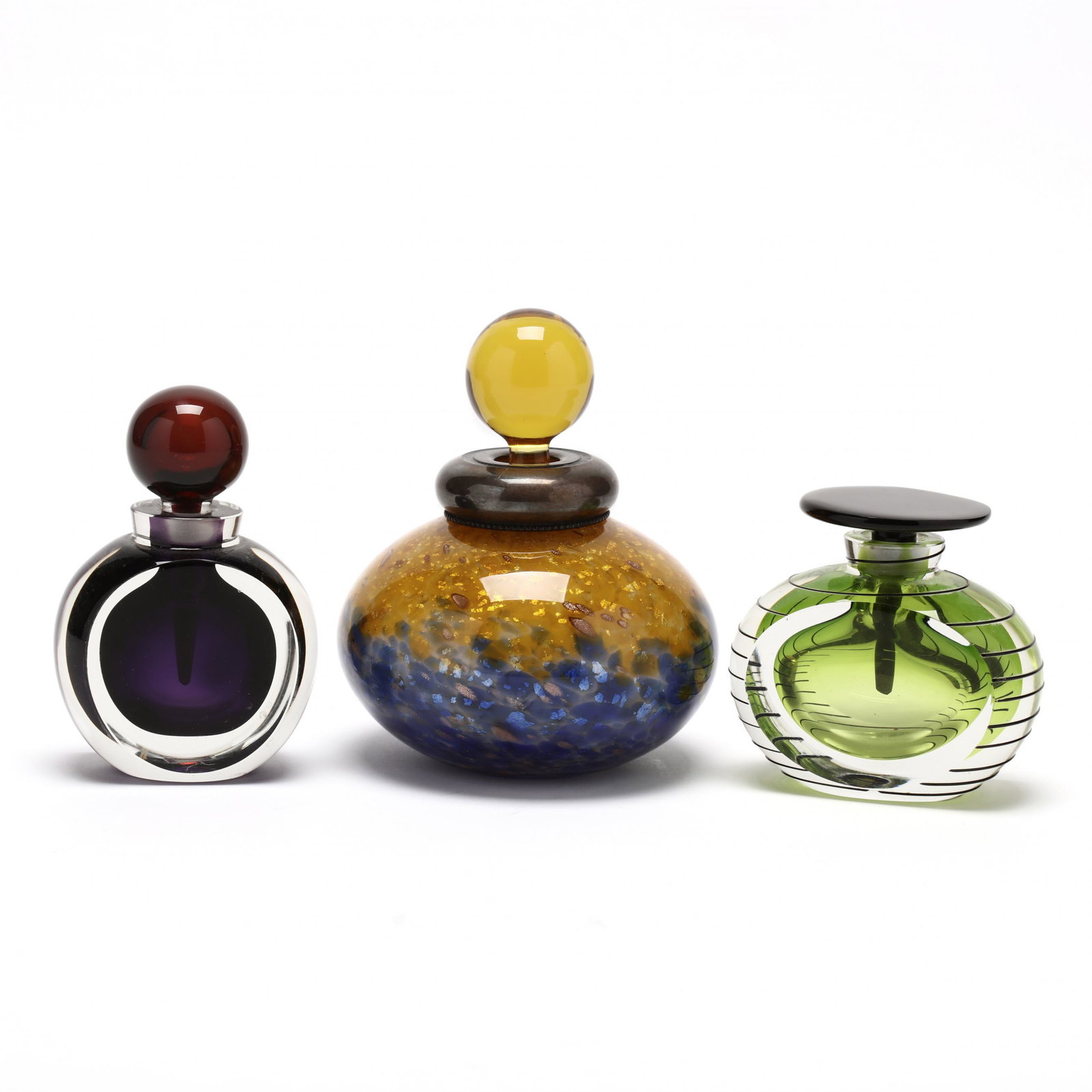 Three Art Glass Perfume Bottles: Three Art Glass Perfume Bottles late 20th century, blown multi color and faceted glass, the largest with an unmarked silver ferrule by Franco Moretti, signed; the other two Sommerso perfume bottles fr