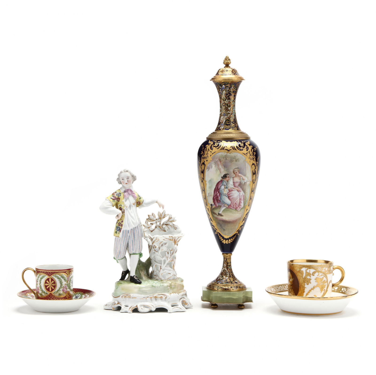 A French Porcelain Grouping: A French Porcelain Grouping20th century, to include a Jacob Petit figurine of a dandy gentleman aside a posy vase marked in blue "JP" (9 3/8 in.); a Sevres style gilt brass mounted vase with cobalt fi