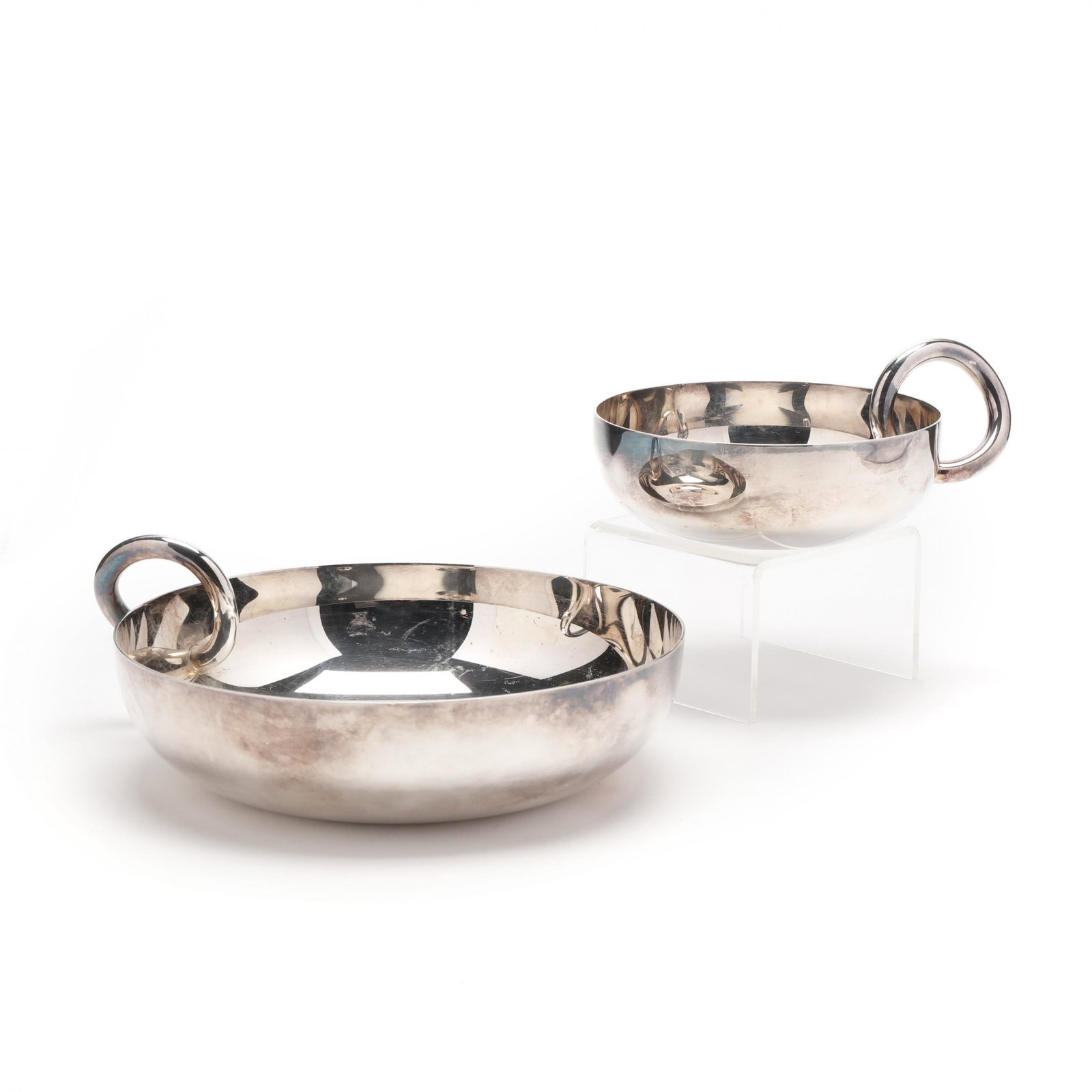 Two Christofle Vertigo Bangle Bowls: Two Christofle Vertigo Bangle Bowlssilverplate, the larger marked to the interior of well and underside, the smaller marked to the underside. 6.75 in. and 4.5 in. diameter Additional high-resolution