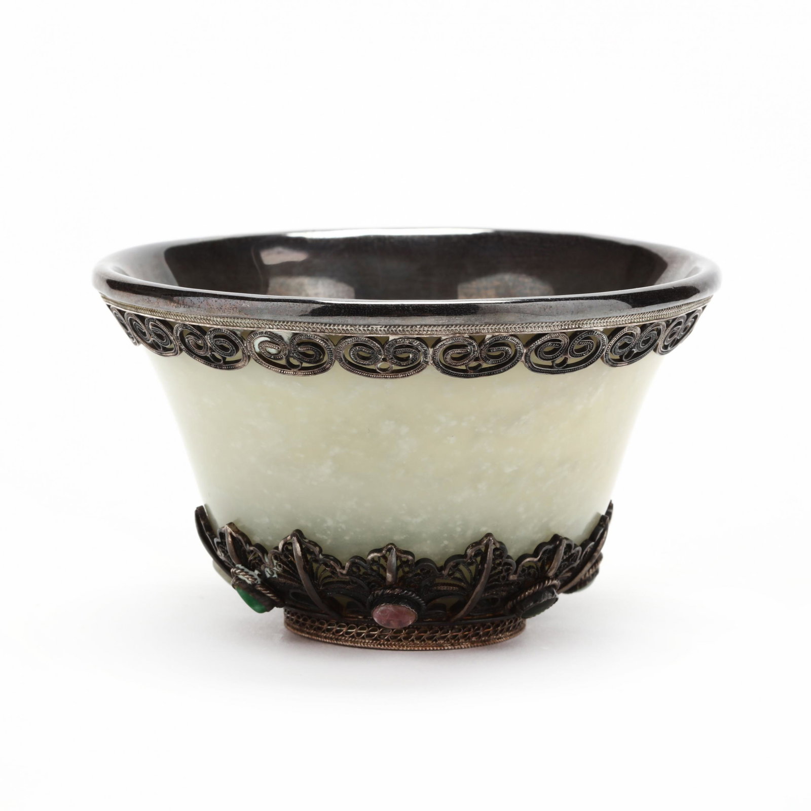 A Chinese Mongolian Silver Mounted Jade Cup: A Chinese Mongolian Silver Mounted Jade Cup Qing dynasty (1644-1912), 19th century, jade cup set in silver mounts with inlaid gems and a filigree ruyi border, inscribed to the jade on underside. 2.25 