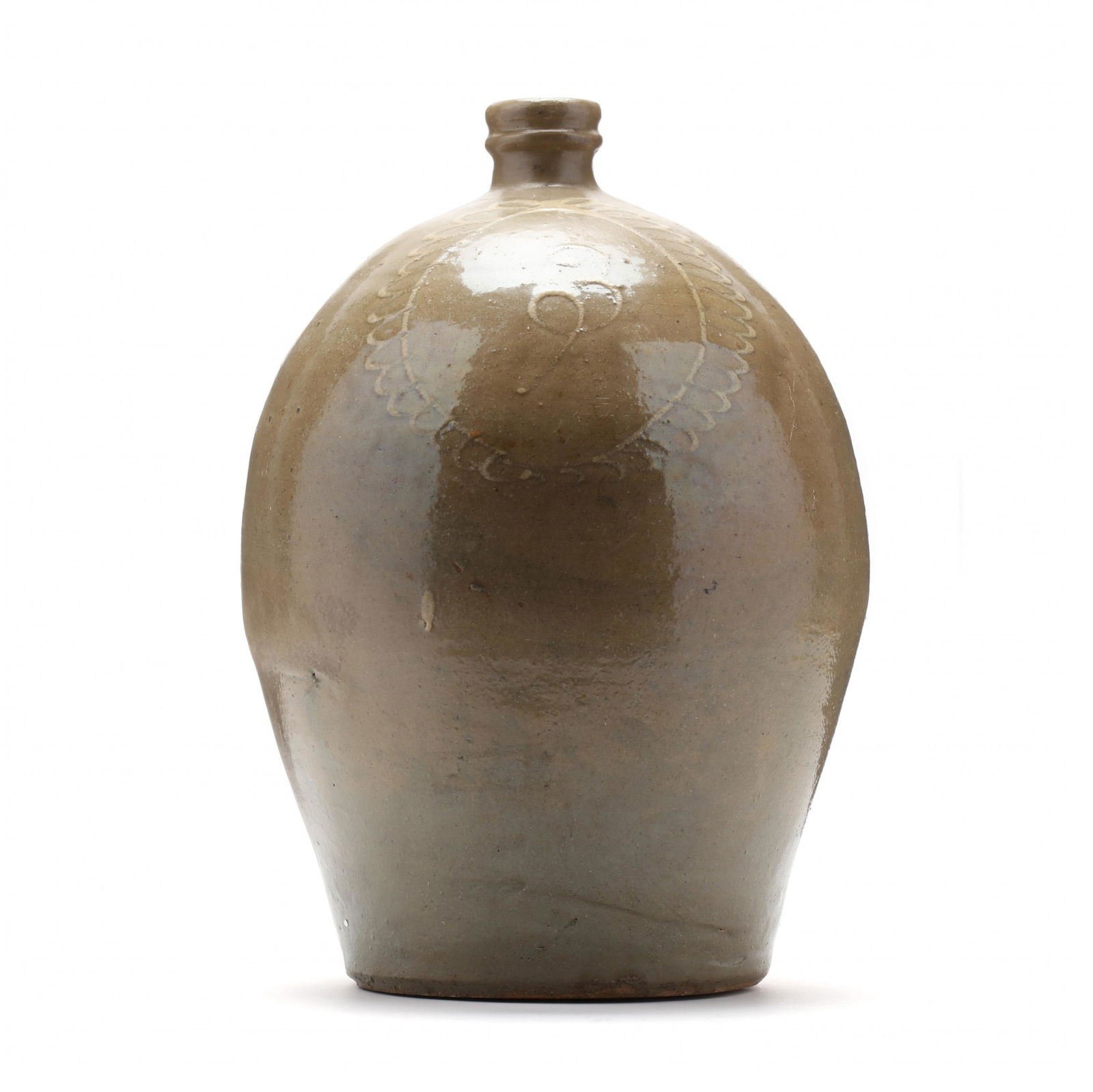 A Three Gallon South Carolina Edgefield Pottery Jug: A Three Gallon South Carolina Edgefield Pottery Jugattributed to Thomas Chandler, circa 1850, well-turned ovoid form, pale olive alkaline glaze, with tooled spout, ribbed single strap handle, the fron