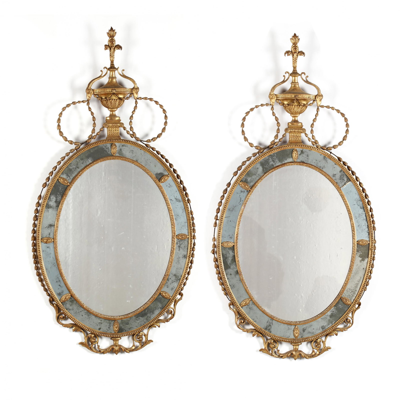 Pair of Antique Adam Style Large Gilt Wall Mirrors: Pair of Antique Adam Style Large Gilt Wall Mirrors late 19th century, oval mirrors surmounted by ram's head urn with flame finial, on plinth with scrolls of bellflowers, outer mirror surround with app