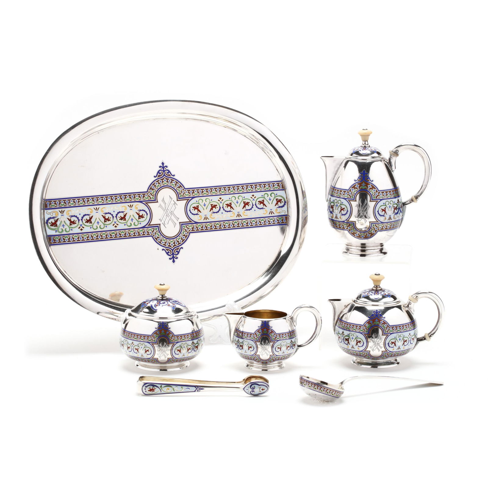 A Russian Silver and Champleve Enamel Tea Service, Mark: A Russian Silver and Champleve Enamel Tea Service, Mark of GrachevSt. Petersburg, circa 1890, 88 silver standard, with Cyrillic maker's mark, seven pieces including: teapot (with removable inner colla