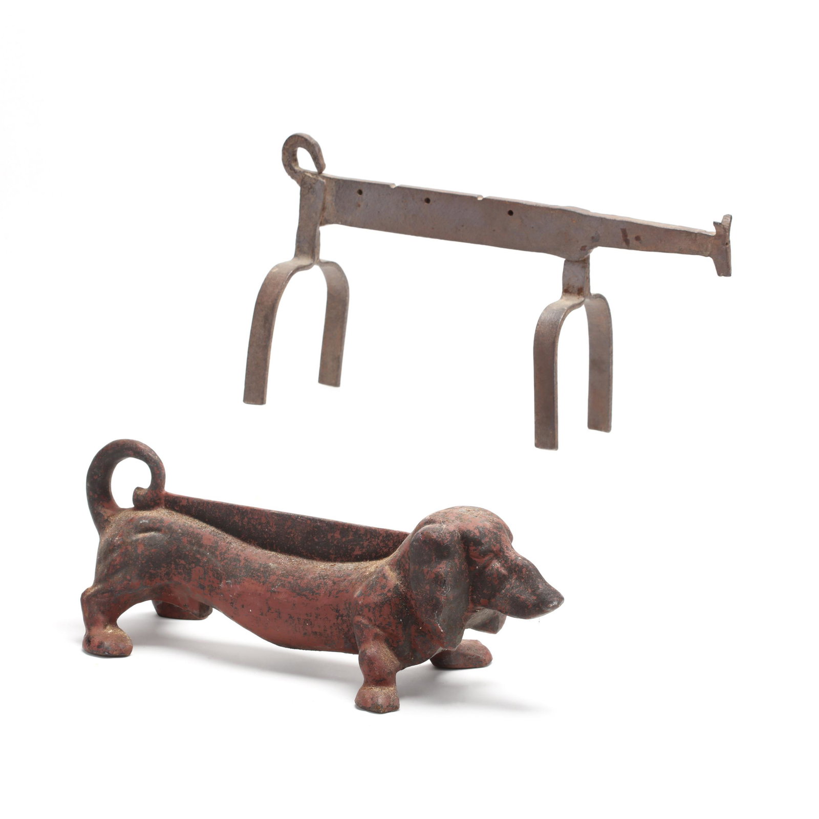 Cast Iron Dachshund Boot Scraper and a Folk Art Andiron: Cast Iron Dachshund Boot Scraper and a Folk Art Andiron 19th-early 20th century, the boot scraper with vestiges of original red paint (5.5 x 16 in.) (overall wear and light oxidation); the andiron han