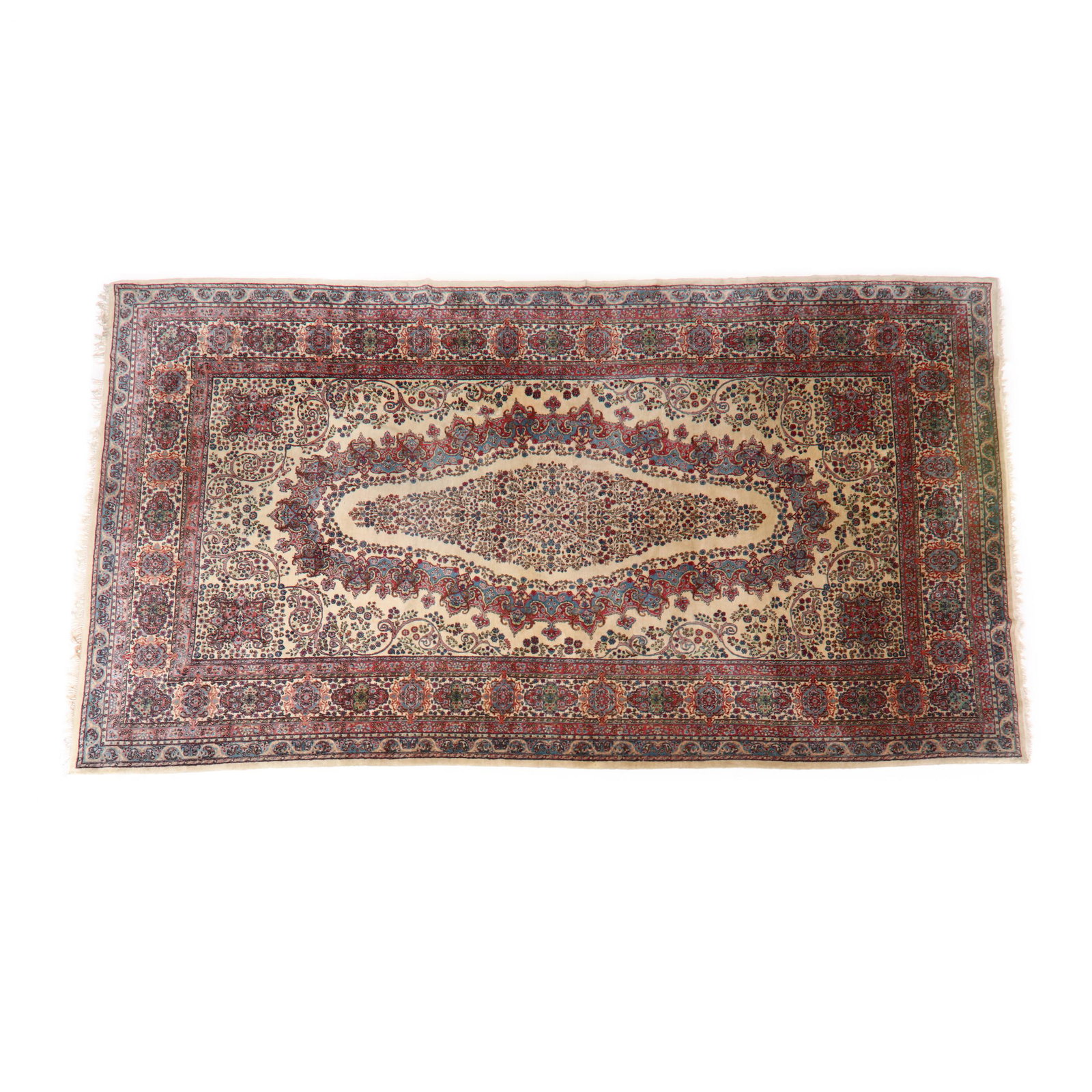 Kerman Carpet: Kerman Carpet field with elongated oval medallion with floral design elements, field with scrolled floral motifs, guard border with rosettes and medallions, outer border with scrolled foliate and styl