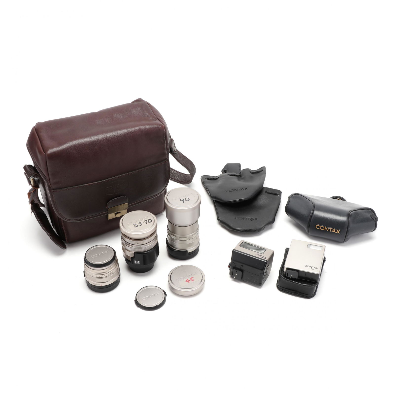 Three Lenses and Accessories for Japanese Contax G-1: Three Lenses and Accessories for Japanese Contax G-1 and G-2 Camerasto include: Carl Zeiss Sonnar T* 90mm, f/2.8 lens with cap; Carl Zeiss Vario-Sonnar T* 35-70mm, f/3.5-5.6 lens with cap; Carl Zeiss