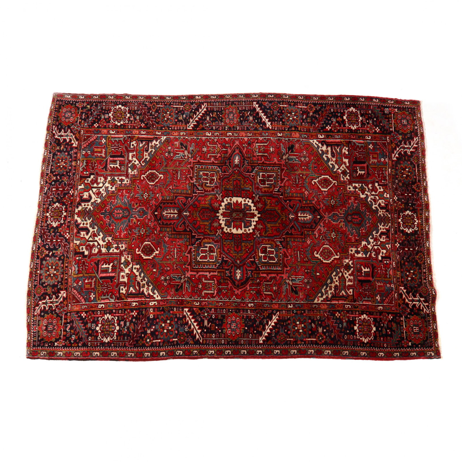 Heriz Rug: Heriz Rugred field with center medallion, dark blue main border with large rosette and serrated leaf motif. 7 ft. 10 in. x 10 ft. 11 in. Private Collection, Western North Carolina Additional high-reso