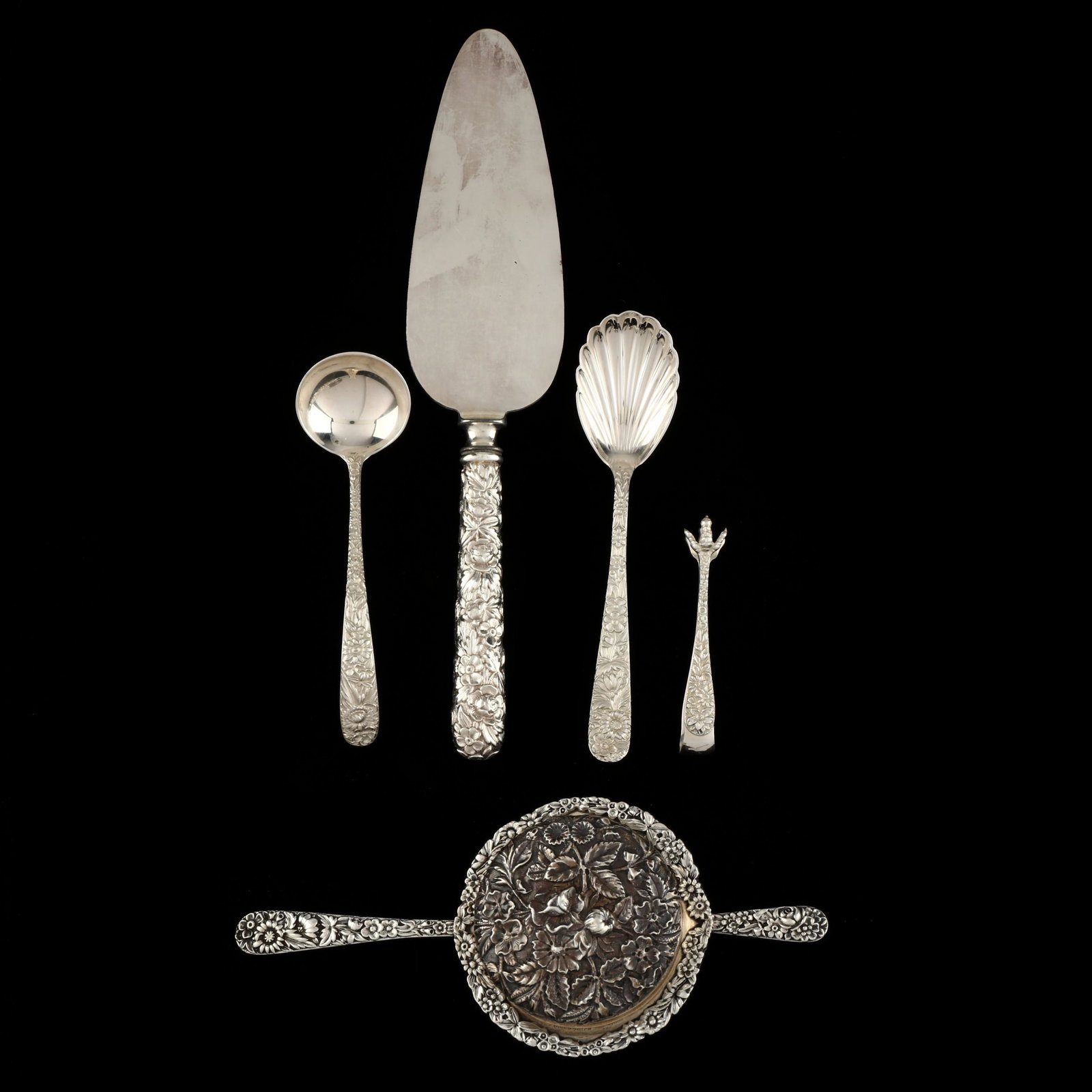 Six S. Kirk & Son "Repousse" Sterling Silver Items: Six S. Kirk & Son "Repousse" Sterling Silver Itemsto include: tea strainer (7 7/8 in.); cream ladle (5 1/8 in.); shell sugar spoon (6 1/8 in.); a pair of diminutive sugar tongs (3 1/8 in.); pie server