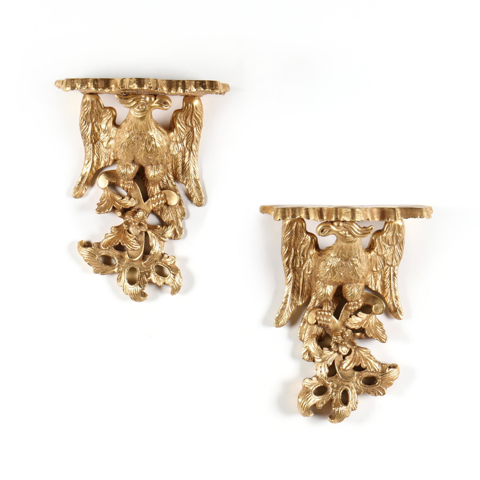 Pair of Eagle Wall Brackets: Pair of Eagle Wall Brackets 20th century, gilt wood, perched eagle with raised wings surmounted by a shaped shelf. 12 x 10 x 7 in. Additional high-resolution photos are available at www.lelandlittle.c