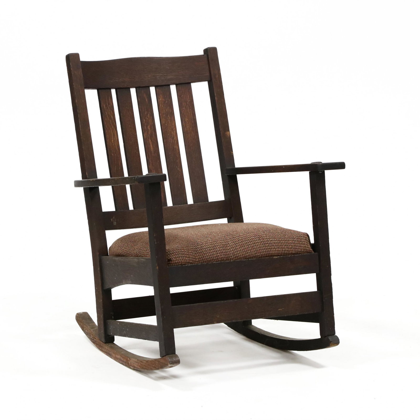 L. & J.G. Stickley, Mission Oak Rocking Chair: L. & J.G. Stickley, Mission Oak Rocking Chair early 20th century, quarter sawn oak, arched crest rail, five-slat back, later upholstered slip seat, through tenon arms, labeled to underside of right ar