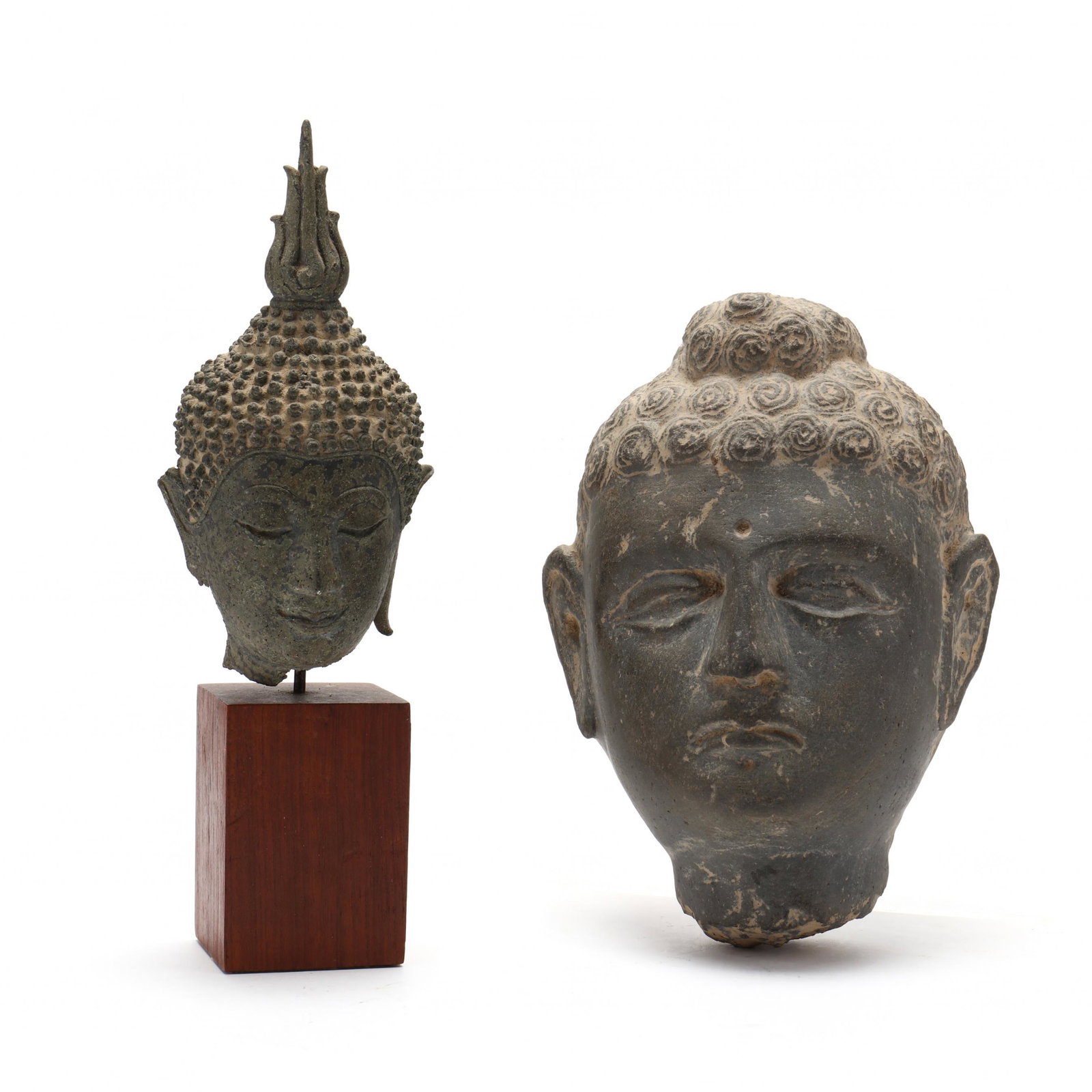A Thai Bronze Head of Buddha and Stone Carving: A Thai Bronze Head of Buddha and Stone Carving antique, includes a stone carving of a face and a finely cast bronze head of the Buddha, mounted in a wooden pedestal, purchased in Bangkok at Thai Antiq