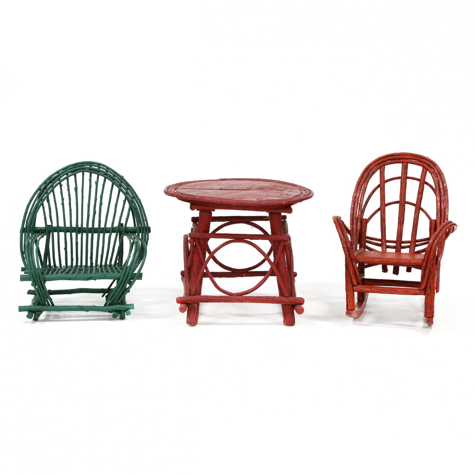 Three Pieces of Painted Twig Child's Furniture: Three Pieces of Painted Twig Child's Furniture late 20th century, including a rocker in red paint, armchair in green paint, and a circular table in red paint. Table 20 x 24 in. diameter From the Perso