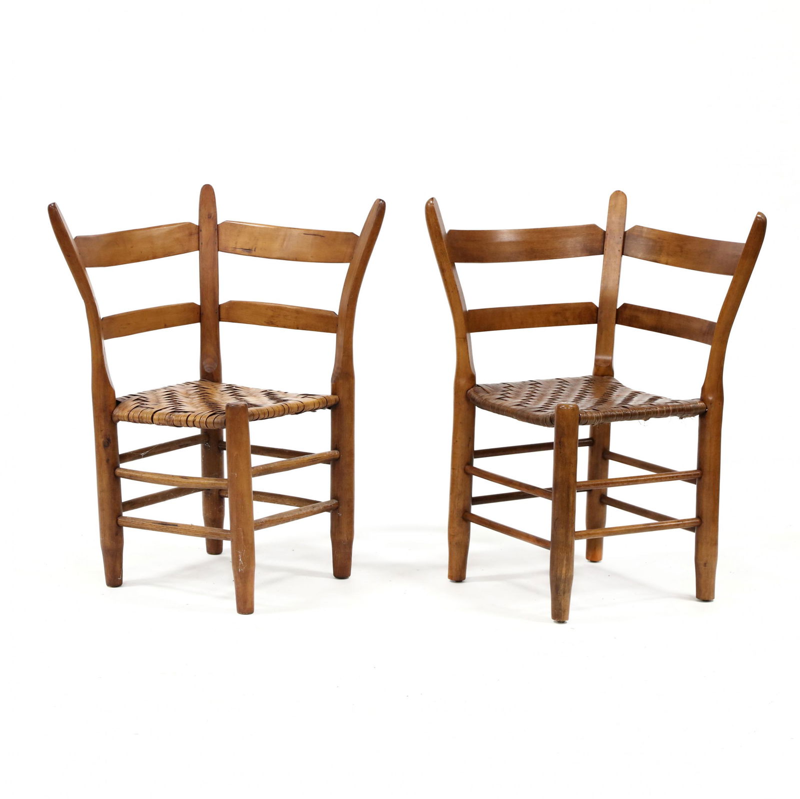 Two Southern Officer's Corner Chairs: Two Southern Officer's Corner Chairs20th century, cherry and mixed woods, ladder back form with splayed stiles, rush seats, turned legs with stretcher base, one marked T to front leg. 33.5 x 21 x 21 i