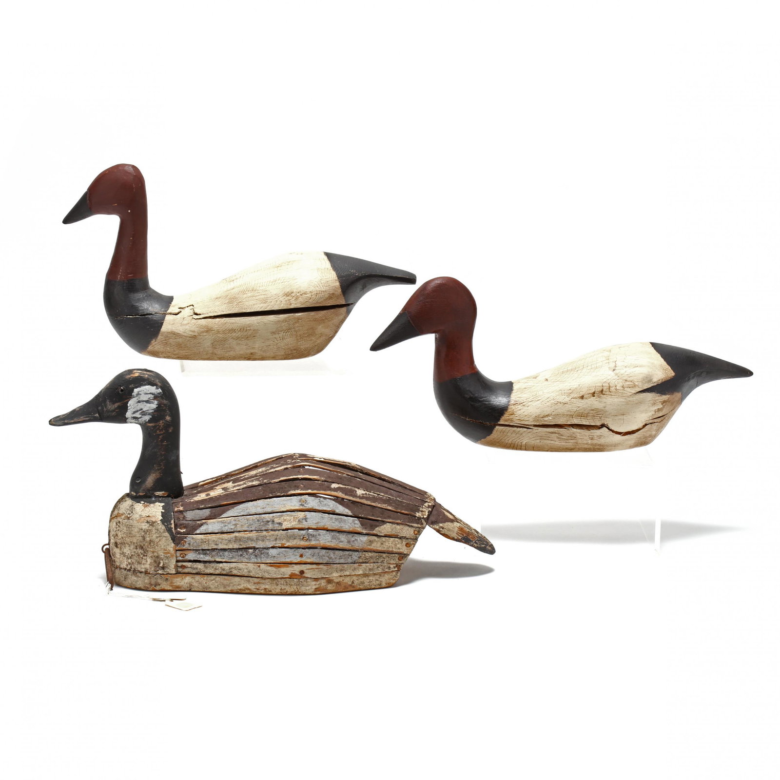 Three Decoys: Three Decoys a vintage working slat and strip goose with Bob Timberlake Collection tag (paint loss and separation of slats) (9.5 x 19 in.); two painted display canvasbacks, one with Bob Timberlake pap