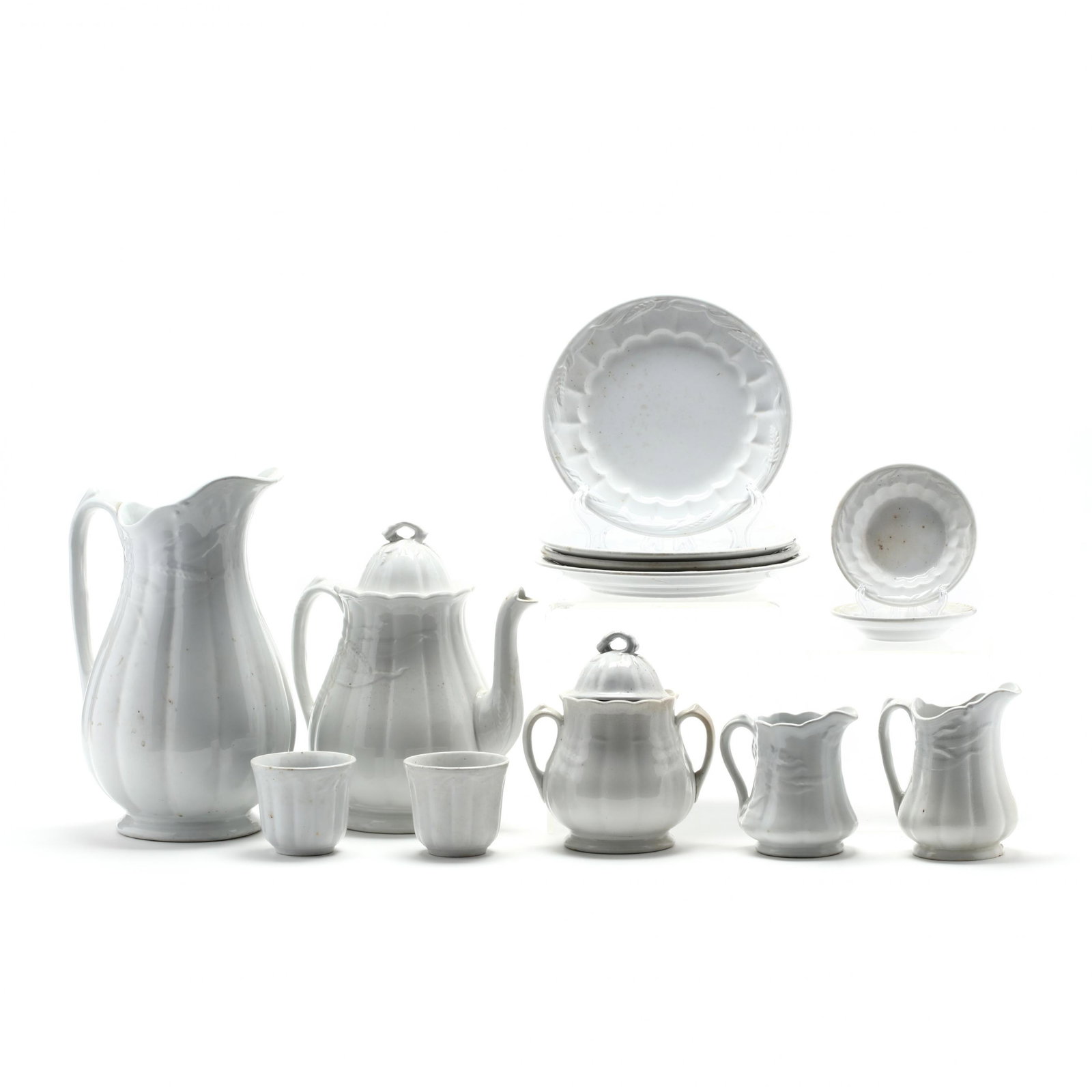 (14) Pieces of Vintage English Ironstone: (14) Pieces of Vintage English Ironstone late 19th century, all embossed with a wheat pattern: a tall water jug and a coffee pot (Jug 12.5 in.) (lid with chip); two creamers (taller 5.75 in.); two bea