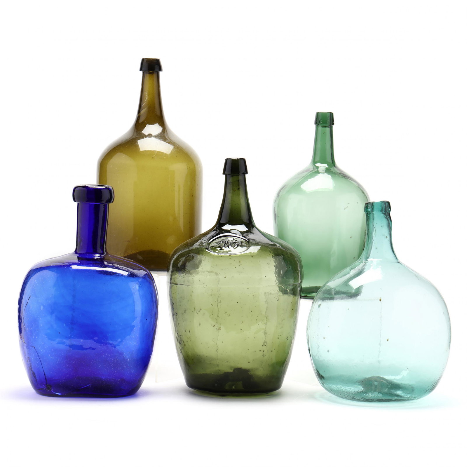 Colorful Group of Five Large Storage Bottles: Colorful Group of Five Large Storage Bottles contemporary, likely Continental, glass tints include olive green, aqua, cobalt blue and forest green. Tallest 16.5 in. From the Personal Collection of Bob