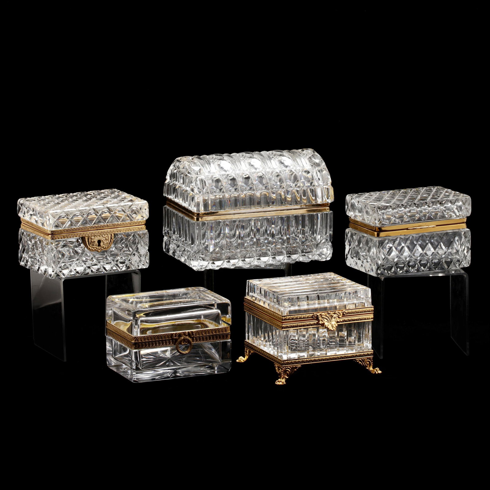 Five French Crystal Dresser Boxes: Five French Crystal Dresser Boxes late 20th century, each with ormolu hinges, the largest with a domed lid, one square form with linear cut pattern, one thick rectangular crystal box with polished sid