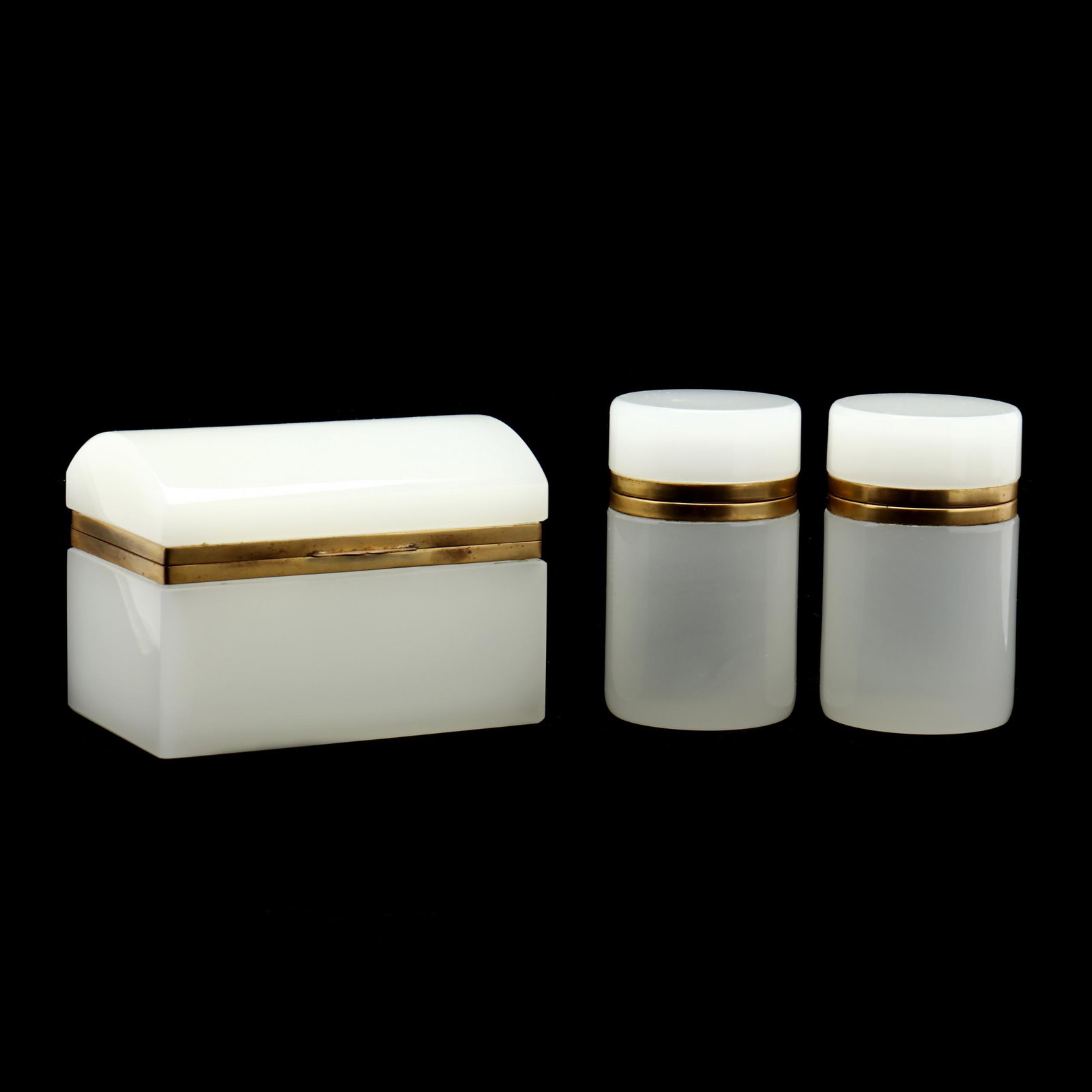 Three Vintage French Opaline Glass Dresser Jars: Three Vintage French Opaline Glass Dresser Jars20th century, white opaline glass with gilt hinged lids, including one rectangular box with a domed lid and a pair of cylindrical boxes, unmarked. Talles