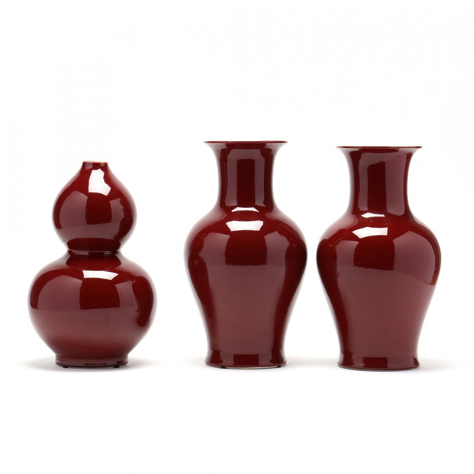 Three Chinese Sang de Boeuf Vases: Three Chinese Sang de Boeuf Vases contemporary, a pair of baluster vases and a double gourd vase 14 in. (tallest) The Collection of Mr. Duggins and Mr. Dunn, High Point, North Carolina Additional high