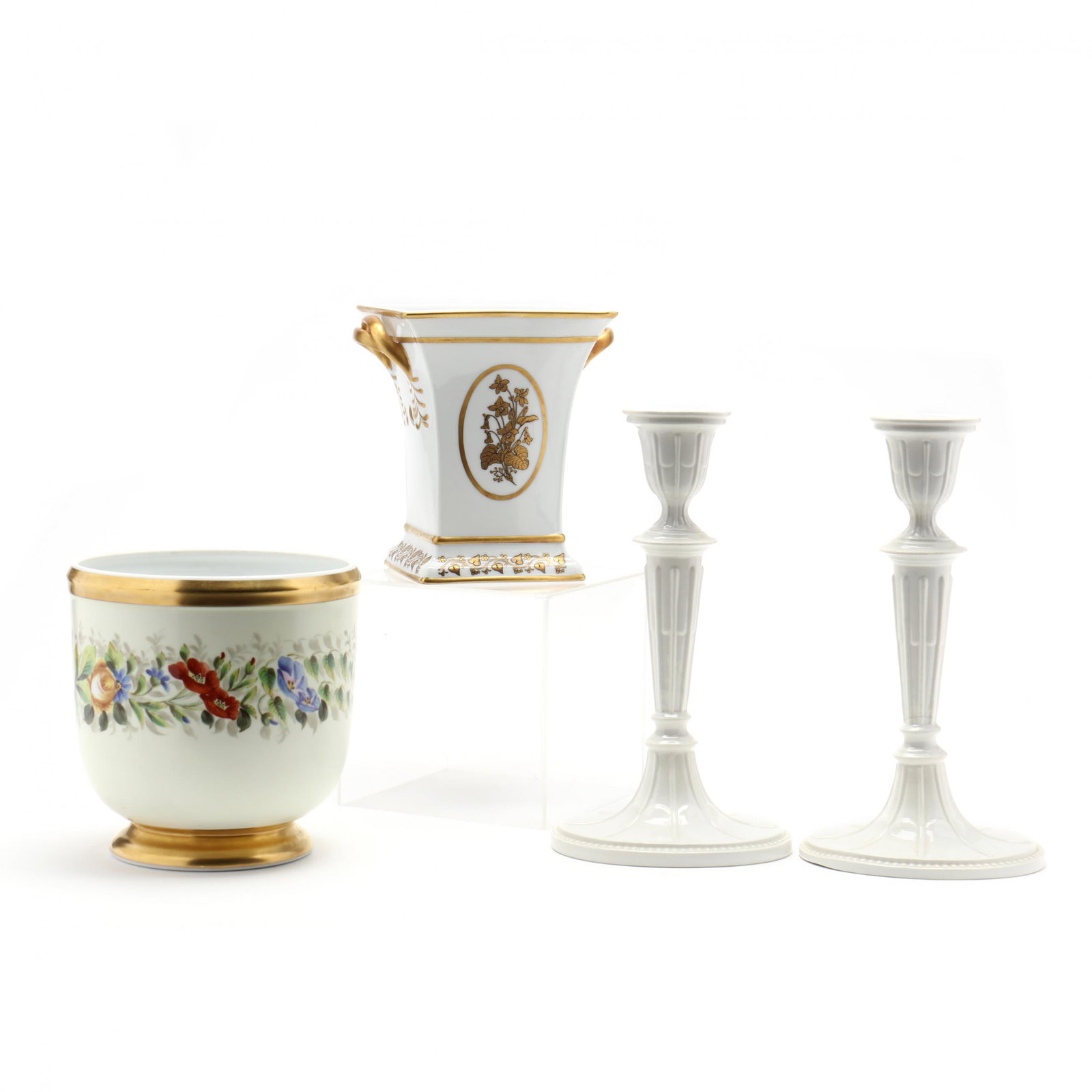 Three Mottahedeh Porcelain Items: Three Mottahedeh Porcelain Items a pair of cream candlesticks (11.25 in.); a flared rim vase with gilded twist handles (7.25 in.); a footed cachepot with running band of flowers and leaves (7.25 in.).