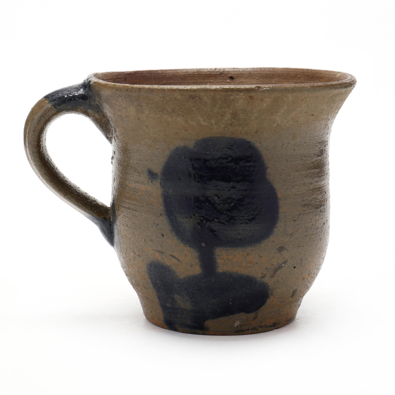 Antique Mid-Atlantic Stoneware Cup: Antique Mid-Atlantic Stoneware Cup circa 1870s-80s, hand-thrown, shaped body with an applied handle, decorated with upright tulip flowers in cobalt. 3.5 in. From the collection of the late Bragg Cox, 