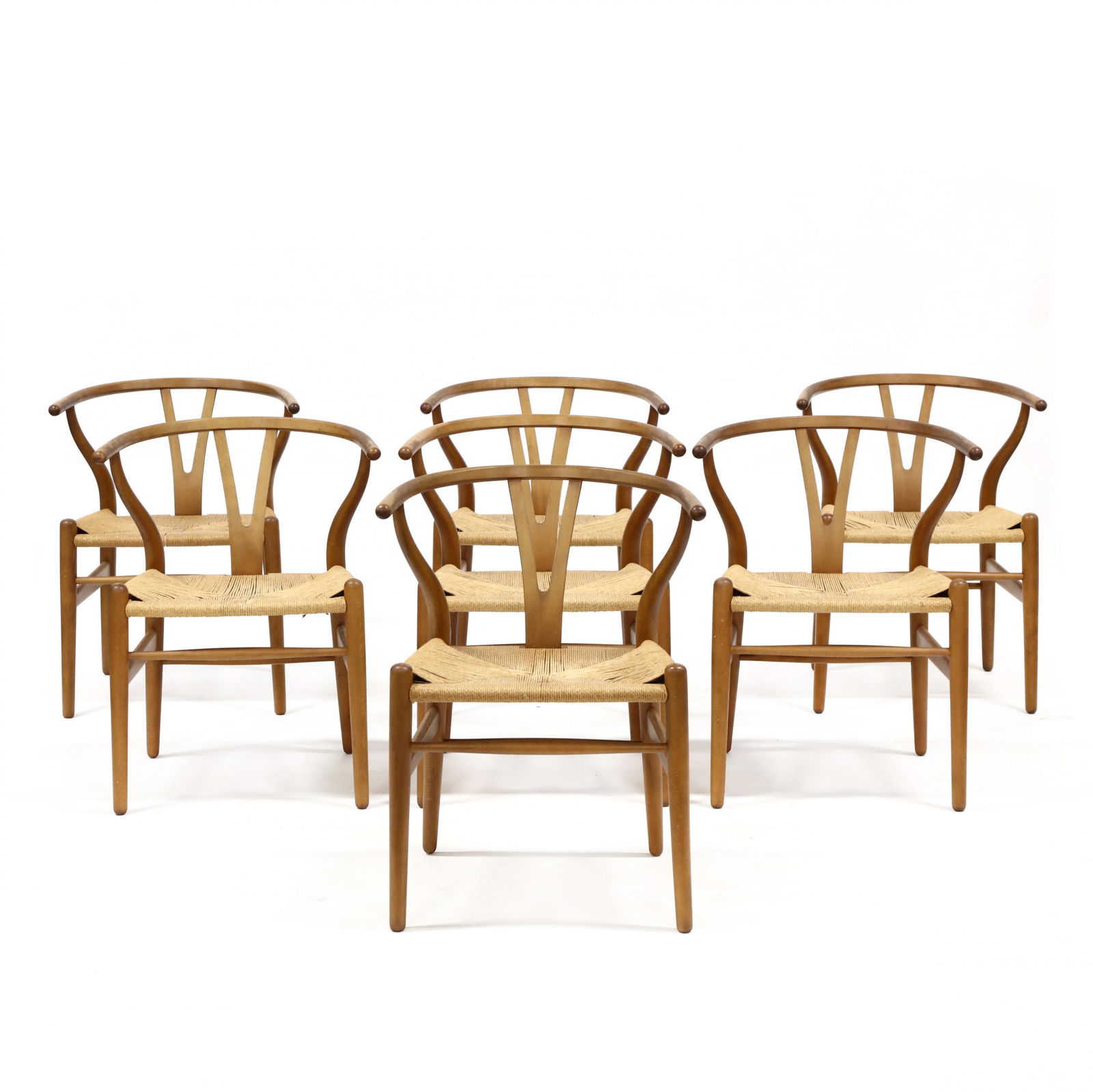 Hans Wegner (Denmark, 1914-2007), Set of Seven Wishbone: Hans Wegner (Denmark, 1914-2007), Set of Seven Wishbone Chairs1960s, Carl Hansen & Son, Denmark, beech bentwood frames with woven seats, labeled. 28.5 x 22.5 x 17 in. From the Collection of Edward and