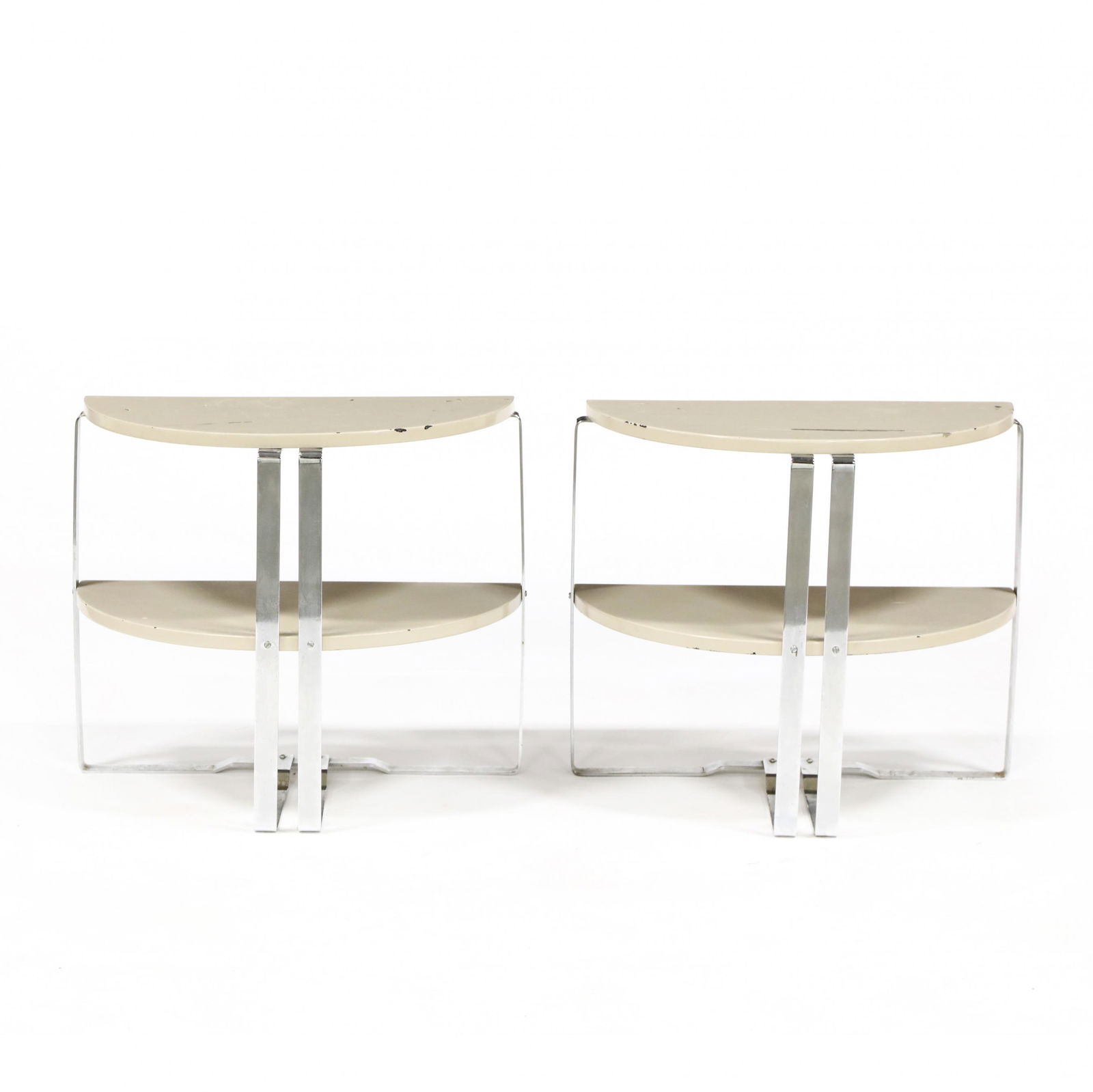Wolfgang Hoffman, Pair of Machine Age Side Tables: Wolfgang Hoffman, Pair of Machine Age Side TablesGerman, 1930s, two tiered form with cream lacquer on chrome legs, unmarked. 21.75 x 26 x 13 in. From the Collection of Julia-Carr Bayler, Richmond, Vir