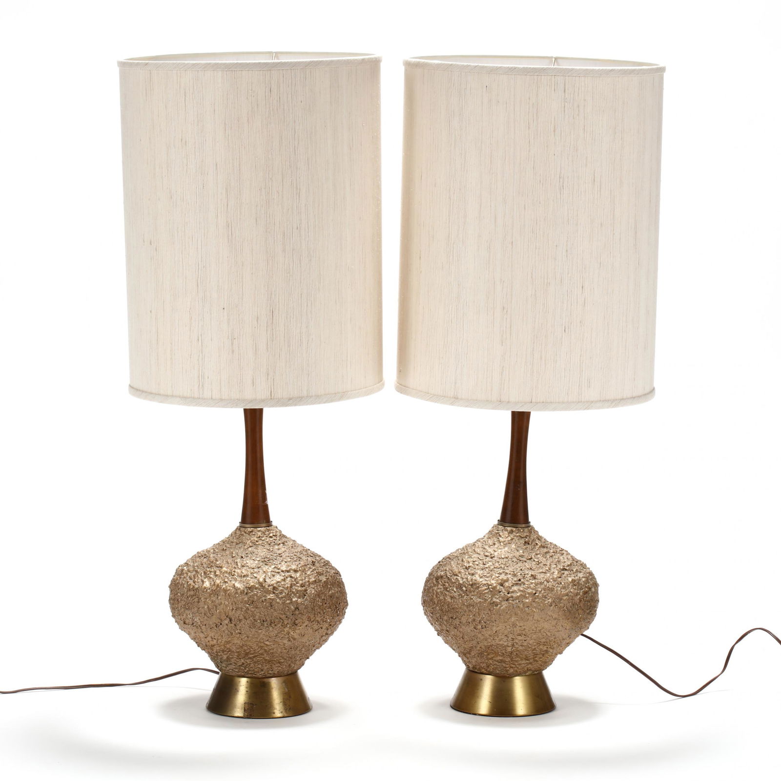 Pair of Mid-Century Table Lamps: Pair of Mid-Century Table Lamps1960s, American, tall drum shades, walnut standard with a gilt composition base on brushed brass rings, appears unmarked. HOA 36 in. From the collection of Nancy & Terry