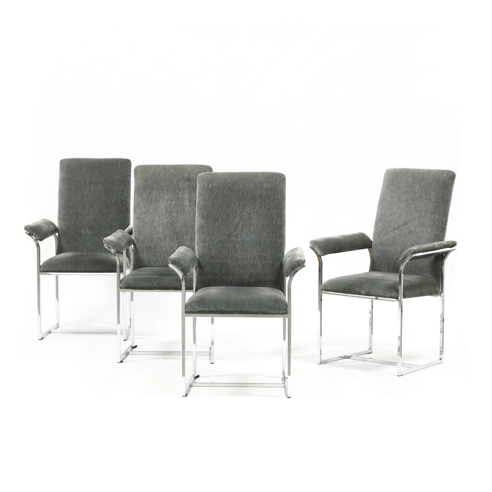 Milo Baughman, Set of Four Steel Arm Chairs: Milo Baughman, Set of Four Steel Arm Chairs circa 1980, polished steel frames with plush grey upholstery, unmarked. 40 x 24 x 19 in., seat height 17 in. From the collection of Nancy & Terry Grier, Wil