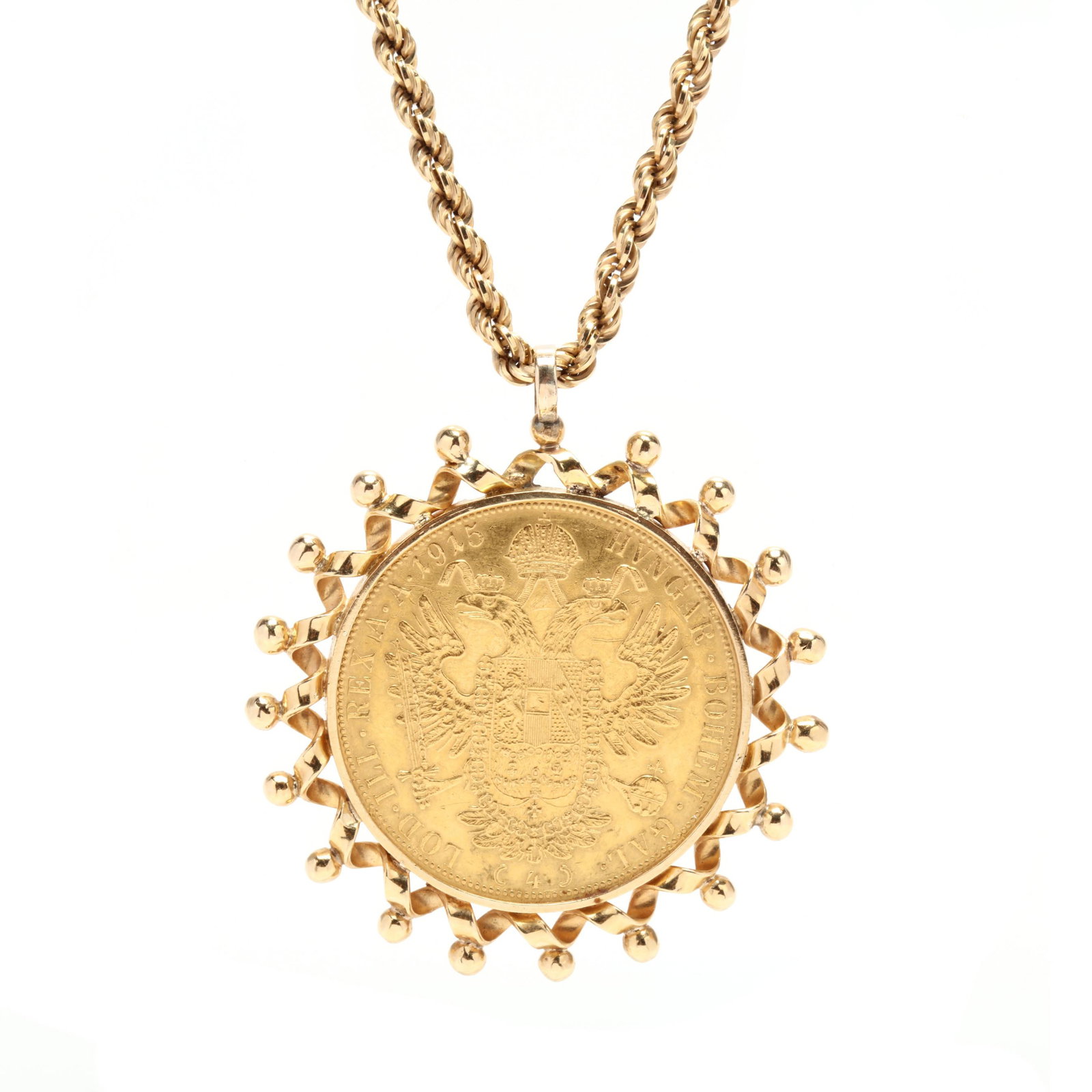 Gold Coin Pendant Necklace: Gold Coin Pendant Necklace the 1915 Austrian 4 Ducat coin with the bust of Franz Joseph on the obverse and with the Arms of Austria on the reverse, the coin mounted in a looped and bead surround and s