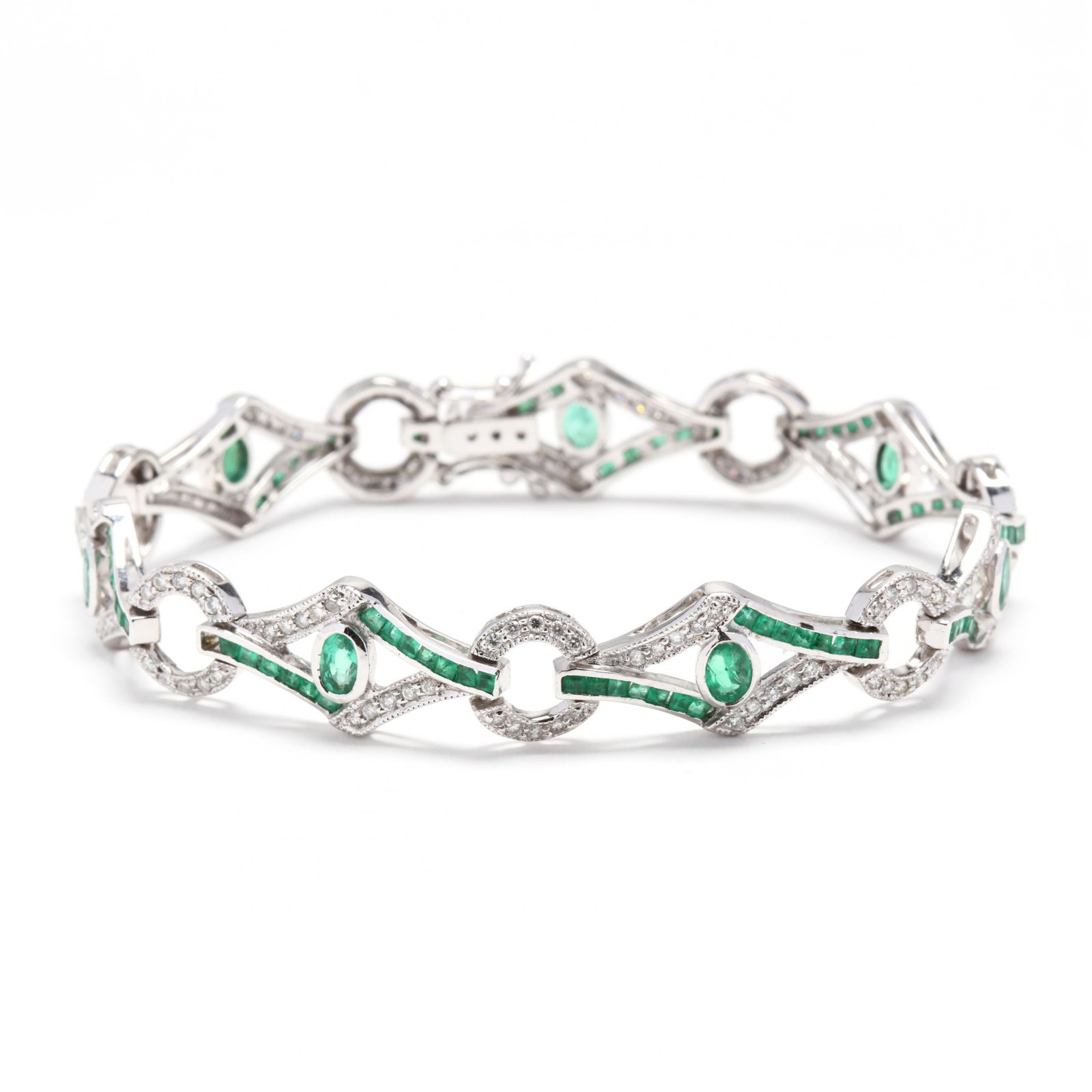 18KT White Gold, Emerald, and Diamond Bracelet: 18KT White Gold, Emerald, and Diamond Bracelet bracelet comprised of marquise shape links each centered with a bezel set oval cut emerald, with channel set square cut emeralds, and with bead set full 