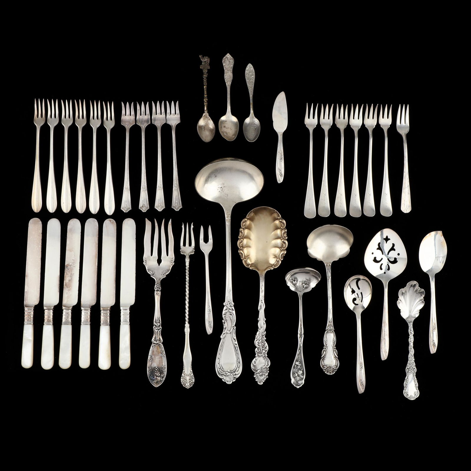 (38) Pieces of American Silverplate: (38) Pieces of American Silverplate to include: soup ladle (11.25 in.), serving spoon with scrolling motifs to a shaped bowl edge and handle (8.75 in.); a jelly spoon, pickle fork, olive spoon, small