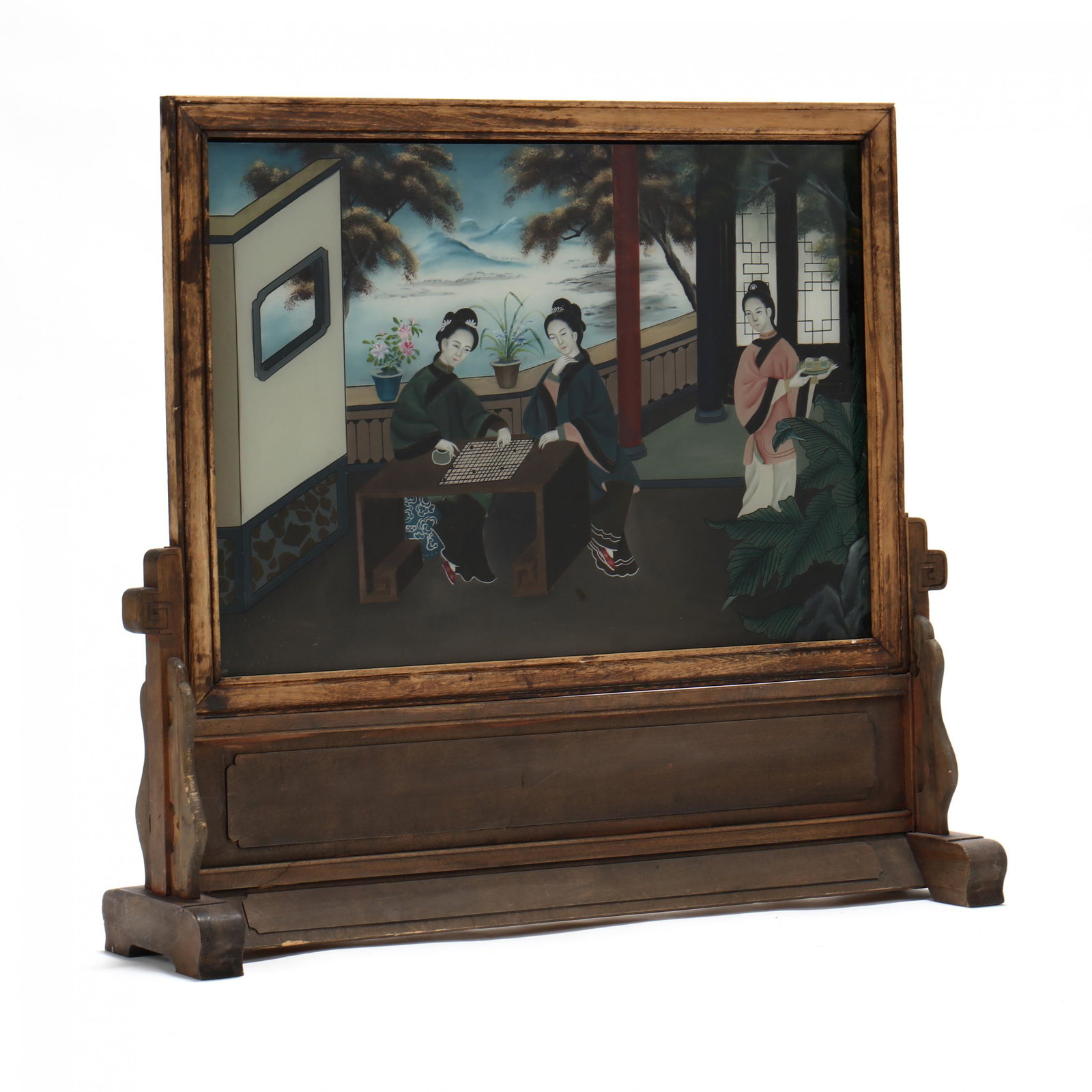 A Chinese Reverse Glass Painted Screen: A Chinese Reverse Glass Painted Screen late 19th or early 20th century, a painting of three elegant women on an outdoor terrace, two playing a game, clear colors and western influence in the backgroun