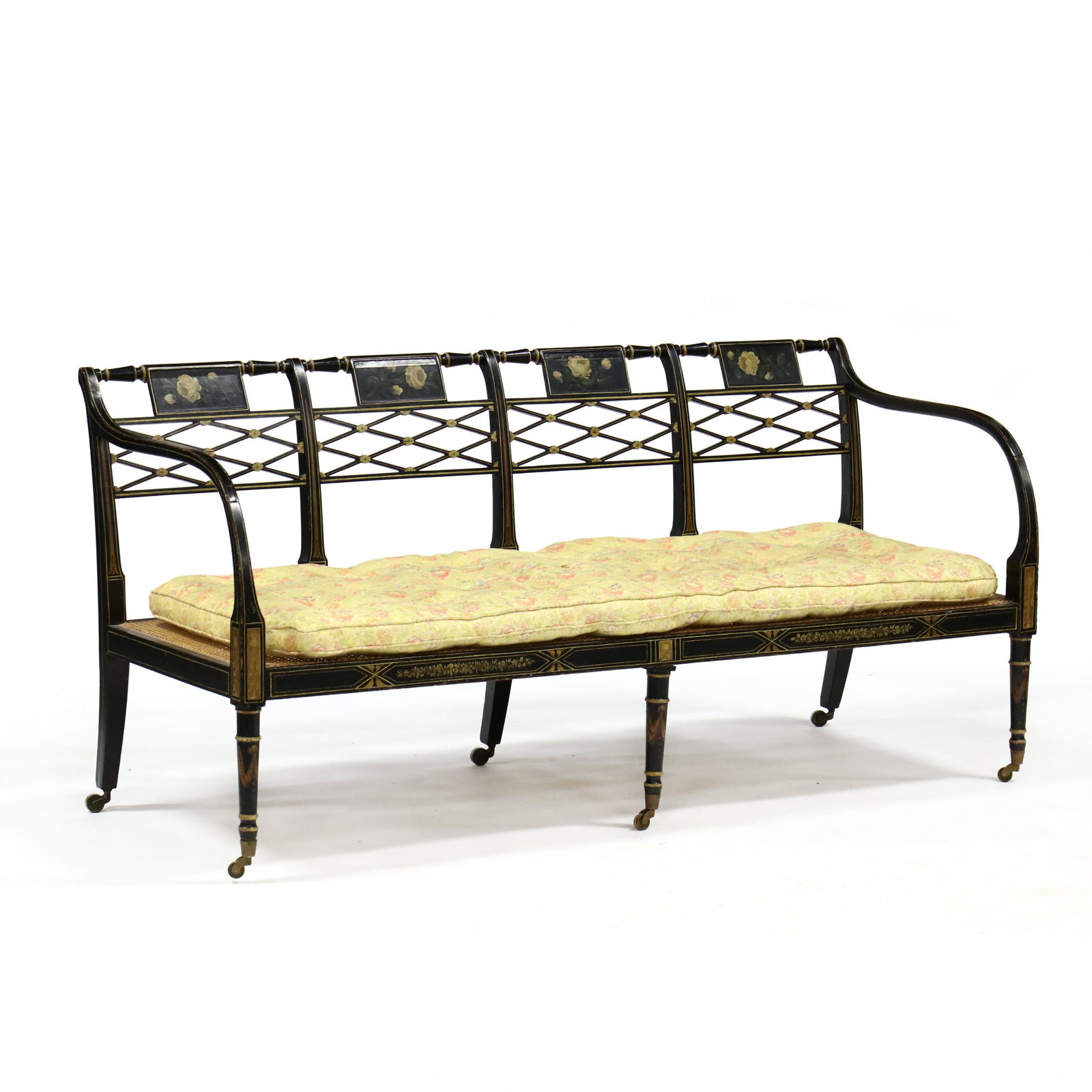 Antique English Painted Bench: Antique English Painted Bench late 19th century, black painted wood with painted floral sprays and gilt highlights, four panel back with open cross-work, cane seat, elongated bentwood arms on six turn