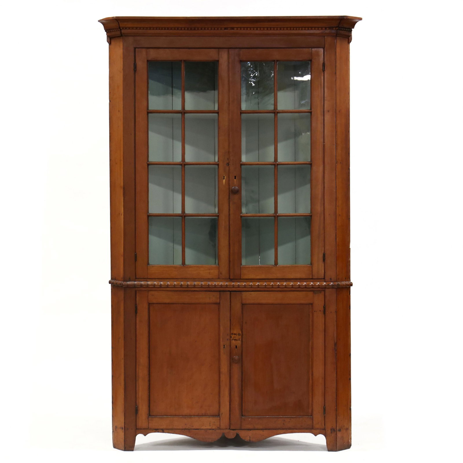 Late Federal Cherry Corner Cupboard: Late Federal Cherry Corner Cupboard attributed Pennsylvania, circa 1830-40, one-part form, secondary is either white pine or poplar (painted); applied cove molded cornice with beaded bottom edge, two 