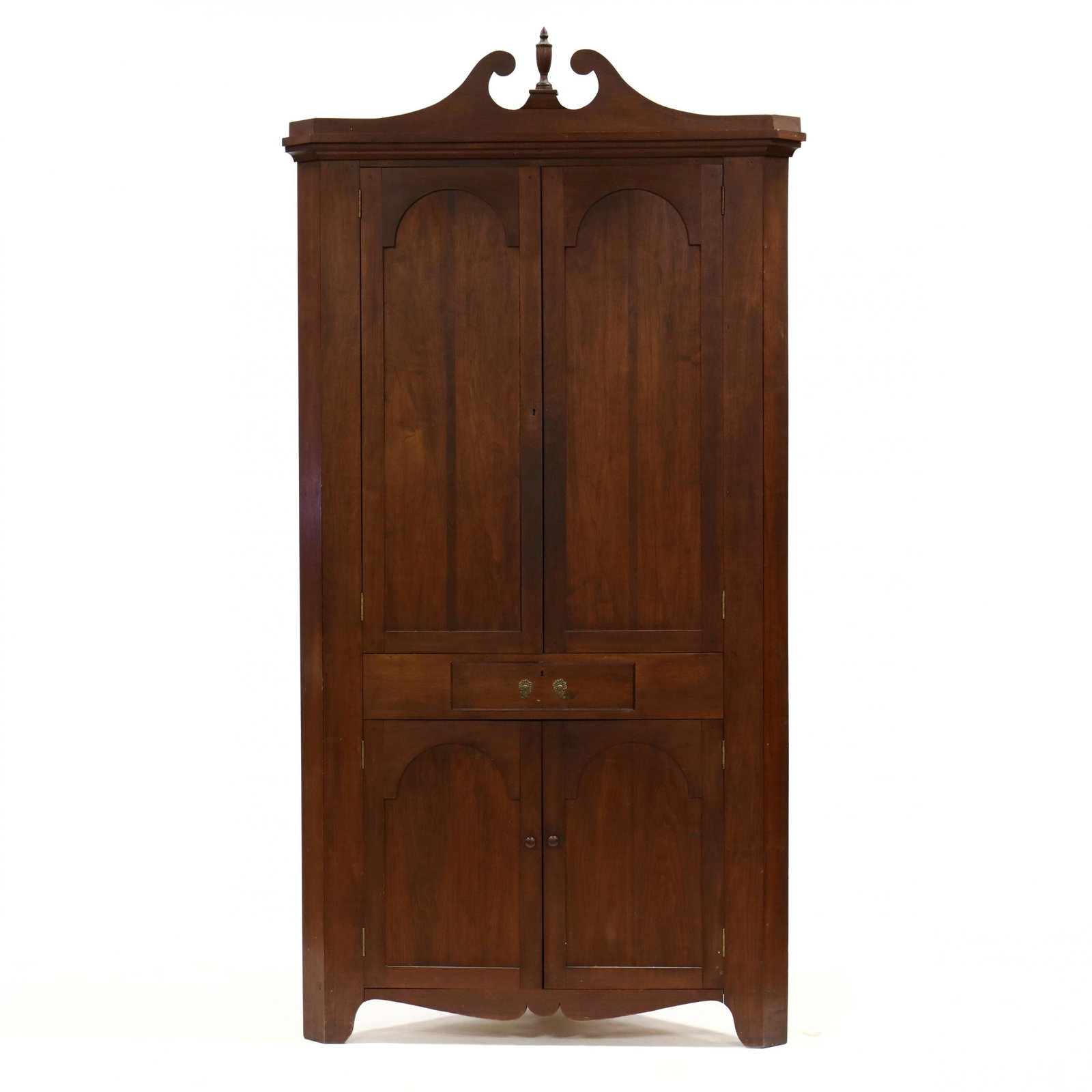 Bench Made Chippendale Style Walnut Corner Cupboard: Bench Made Chippendale Style Walnut Corner Cupboard 1930s, Virginia, one part form, broken arched pediment with turned urn finial, two hinged tombstone paneled doors with shelved interior, central wai